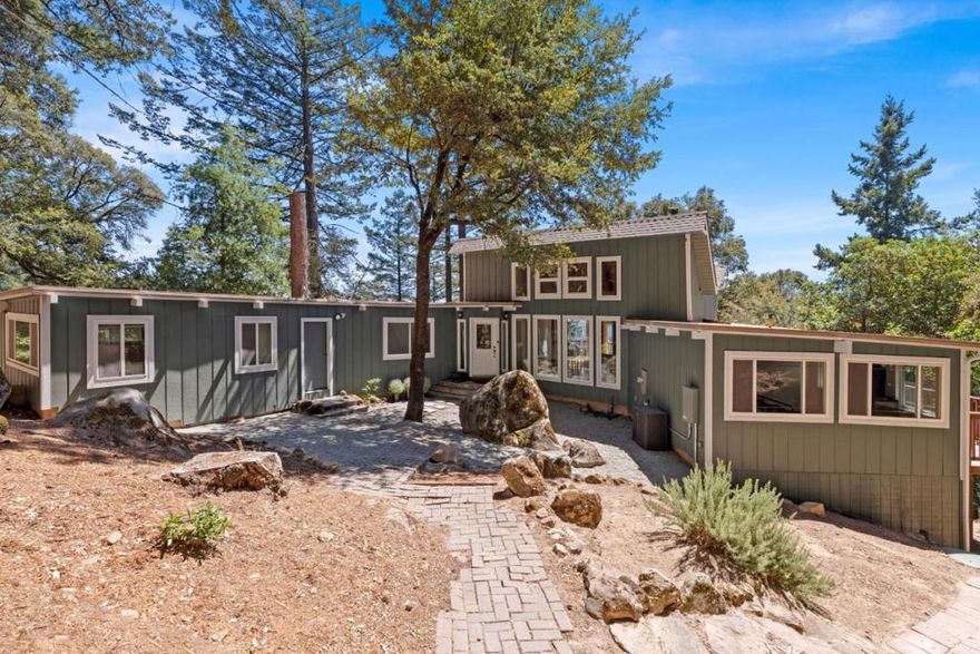 Relax beneath the forested canopy enjoying stunning views of the sparkling Monterey Bay and white water breaking at Moss landing. Soaring ceilings and natural wood beams, recently renovated kitchen with granite countertops, new cabinetry, and updated flooring; prepare meals while taking in the Monterey bay and distant vineyard covered range views through stunning, oversized designer windows. Downstairs living space could potentially become an attached ADU with the addition of a kitchenette, guests, rental income, or multigenerational living. Outdoors, a large deck, plenty of flat land for additional parking, and a Zen feeling Moss Covered Boulder Garden with ancient cultural grinding stones are the perfect place to find peace and harmony with nature. Located in the welcoming Las Cumbres community, residents enjoy exclusive access to a pool, tennis and basketball courts, sport field, bocce, playground, community barbecue area, garden, and Fire Station for added peace of mind. Detached 2-car garage with small workshop. Madrone HighSpeed Internet. Automatic failover generator keeps the power on when utility power is unavailable. Award-winning Los Gatos High School. More than a home, a lifestyle, combining tranquil mountain living with the vibrant amenities of a tight-knit community.