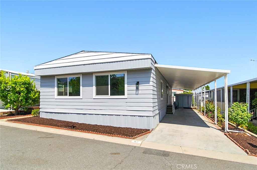 Beautifully Remodeled Home in Friendly Village Senior Community – A Must See! Step into this stunningly remodeled 1971 Skyline home, offering 2 spacious bedrooms and 2 beautifully updated bathrooms with step-in showers. This charming residence has been thoughtfully upgraded throughout, combining comfort, style, and functionality. Inside, you’ll find brand-new laminate wood flooring, fresh interior and exterior paint, and all-new double-pane windows that fill the space with natural light. The remodeled kitchen is a true highlight, featuring gorgeous quartz countertops, crisp white shaker cabinets accented with sleek charcoal handles, and plenty of space for culinary creativity. Both bathrooms have been tastefully updated with hard surface counters, matching white shaker cabinetry, elegant gunmetal grey hardware, and black charcoal faucets — creating a cohesive and modern aesthetic. Enjoy peaceful afternoons in the spacious enclosed porch, perfect for relaxing with a cup of tea and a cool breeze. For added peace of mind, this home includes a built-in security alarm system. The concrete driveway provides convenient parking, and the low-maintenance yard lets you spend more time enjoying the vibrant community around you. Located in the desirable and welcoming Friendly Village Senior Community, this move-in ready home is waiting for you. Don’t miss the opportunity to make it yours — schedule your tour today! Restrictions may apply. Price does not include charges for escrow, title, and registration, sales tax, or closing fee. sf. is approximate