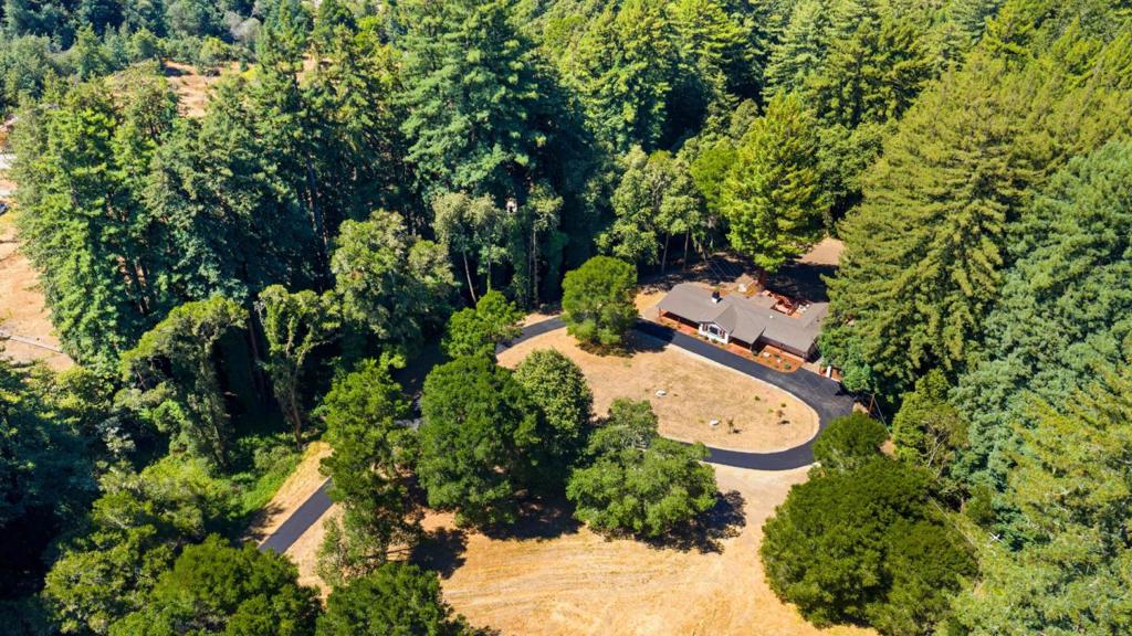 This is your opportunity to own a rare beautiful luxury-style ranch with unmatched sunrises. Set on almost 7 sunny usable acres just 6 minutes to Hwy 1 and downtown Aptos, 1251 Cox Rd blends privacy, convenience, and a fully remodeled single-level layout. The main residence features 4 bedrooms and 3 baths, including two ensuite bedrooms with the primary suite privately positioned on its own wing. Facing due east, the home welcomes golden sunrise light across the great room and front acreage. Outdoors, expansive level areas invite gardens, orchard, hobby vineyard, play fields, or future amenities. The backyard provides an open canvas for a pool, tennis court, or even an outdoor oasis. A detached guest house adds flexibility for multigenerational living, guests, or office/studio use, and adjoins a large garage/workspace. Recent updates deliver turnkey comfort; modern finishes, refreshed baths, and a cohesive palette throughout, while the single-story design keeps life simple. Enjoy the best of Aptos living: room to breathe, quick access to beaches, shops, and schools, and an easy commute corridor to Santa Cruz or Silicon Valley. A rare acreage opportunity with a fully remodeled ranch, separated bedroom wings, and true indoor-outdoor potential; ready for your next chapter.