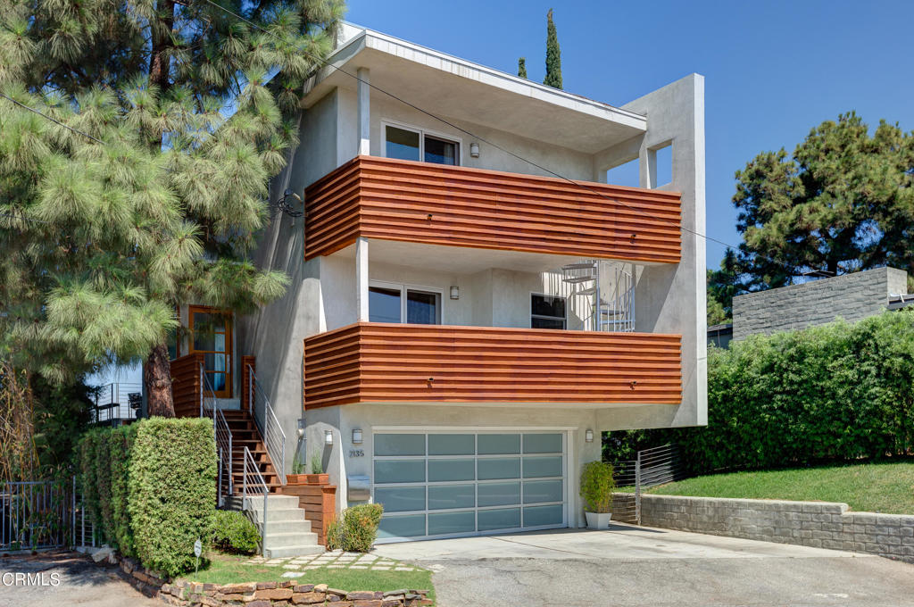 Experience breathtaking views from this modern residence in Echo Park, located directly across from the stunning Elysian Park in Los Angeles. Originally redesigned by the acclaimed architect Barton Choy in 2007, this home offers 360-degree panoramic vistas of Downtown LA, the iconic Hollywood sign, and the San Fernando Valley. Situated on a 9,467 sq. ft. lot, you'll enjoy a spacious entertainer's deck that seamlessly integrates indoor and outdoor living, along with terraced walkways, mature landscaping, and spectacular evening sunsets. The balconies provide prime views of the Dodger Stadium fireworks.The entry level boasts an open floor plan featuring a living room and dining area, each with large sliding glass doors leading to view decks, alongside a remodeled kitchen and powder room. The upper level includes two primary suites; one with a glass-enclosed circular Jacuzzi tub offering bird's-eye views, and the other with its own en-suite bathroom. The lower level comprises a large den, office, and a 3/4 bath with a private entrance. The garage is equipped with a 240-volt outlet.This tranquil and serene 2,278 sq. ft. home is a true slice of paradise, all while being just minutes away from the vibrant and exciting Echo Park.