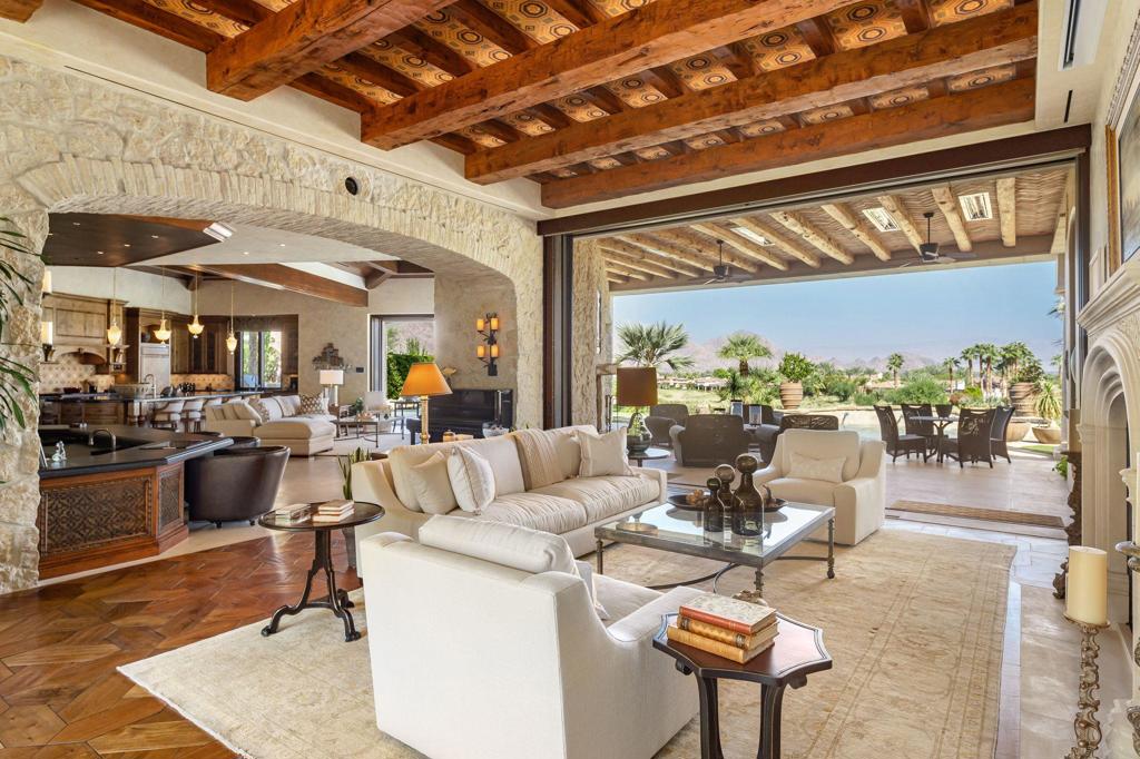 Perched on the top of Tradition above the 12th hole, this ''Smart'' home took over 2 1/2 years to build with no expense spared and will not disappoint. Gorgeous Tuscan Style home with 4 bedrooms, (including Casita with 2 bedroom suites and living room), office, and massage room. Entertain your guests in the intimate courtyard pavilion with fireside sitting area and charming dining space. Motorized pocketing doors in living room, family room, and courtyard pavilion create unparalleled inside/outside entertainment. Be prepared to look up, as every ceiling has been uniquely designed with the finest craftsmanship. The formal living room transforms into a media room with a touch of a button. Handsome fully equipped bar sits at the heart of the home and connects the living spaces for seamless entertaining. Gourmet kitchen with generous pantry will delight any chef and keeps them open to the action. Master Suite has stunning views, custom fireplace, and exquisite master bath, dual closets and opens to an incredible private outdoor shower Car and wine lovers enjoy the downstairs wine cellar and pristine four car garages with access via elevator or stairs. Furnished per Inventor