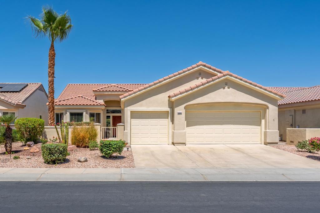 Sun City Palm Desert - St. Croix. Ideally located just down the street from the Lakeview Clubhouse, this sought-after St. Croix floor plan offers comfort, versatility, and style. The home features 2 bedrooms, 2 bathrooms, a spacious den, a bonus/hobby room, and a 3-car garage. The north-facing backyard showcases low-maintenance desert landscaping, including citrus, and an extended patio perfect for outdoor living. A gated south-facing courtyard with paver patio enhances curb appeal while offering a welcoming entry. Inside, the home is clean and ready for your personal touch. Diagonally laid tile flows through much of the home, while the open great room features recessed lighting and direct access to the patio. The kitchen is well-equipped with corian counters, a breakfast bar, center island, pull-out shelving, and maple cabinetry that also extends into the bathrooms. The spacious den sits just off the great room, with the bonus/hobby room beyond--ideal for crafts, fitness, or office space. The primary suite offers laminate wood flooring, patio access, a large walk-in closet with mirrored doors, and an en-suite bath with dual sinks and a stall shower with textured glass doors. The guest bathroom includes a tub/shower combo with cultured marble surfaces, and the guest bedroom features mirrored wardrobe doors. Additional highlights include a laundry room with cabinetry and utility sink, plus a 3-car garage with built-in storage.