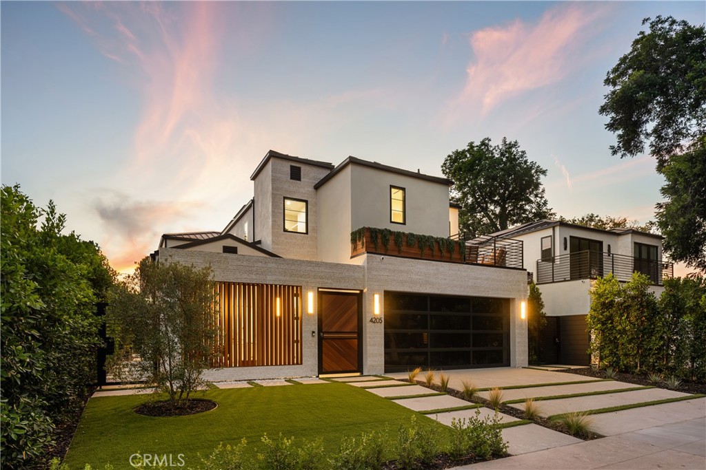 A bold statement in modern luxury living, this brand-new construction home is situated on a quiet tree-lined street in prime Studio City. Showcasing thoughtful design throughout, the bright and airy open-concept floor plan is defined by lofty ceilings and a spacious, flowing layout. At the heart of the home lies every culinary enthusiast’s dream, a designer kitchen equipped with a La Cornue range as its centerpiece, high-end Thermador appliances everywhere else, a stunning waterfall island and walk-in pantry. The adjacent living room and formal dining area are highlighted by a dramatic fireplace framed by custom built-ins and two oversized sliding glass doors that seamlessly extend your living space outside, ideal for entertaining. Step out to your tranquil backyard retreat and enjoy the best of outdoor living with a sparkling pool/spa, built-in BBQ and plenty of patio space for sun-soaked lounging or al-fresco dining. Upstairs, you’ll find three generously sized ensuite bedrooms and a dedicated laundry room. The primary suite features a private balcony, custom walk-in closet and spa-inspired bathroom, complete with a soaking tub, steam shower and double vanity. Boasting its own private entrance, the attached guest suite offers a living room with a kitchenette and ensuite bedroom with a walk-in closet – perfect for a home office/gym/studio, guests or multigenerational living. Additional highlights include a wine cellar, smart home features (Ring security system, Nest thermostat, Lutron lights), a gated front courtyard and two-car garage. This property is ideally located within the top-rated Carpenter School District and just moments away from Ventura Boulevard’s vibrant shopping and dining scene, the Studio City Farmers Market and so much more.