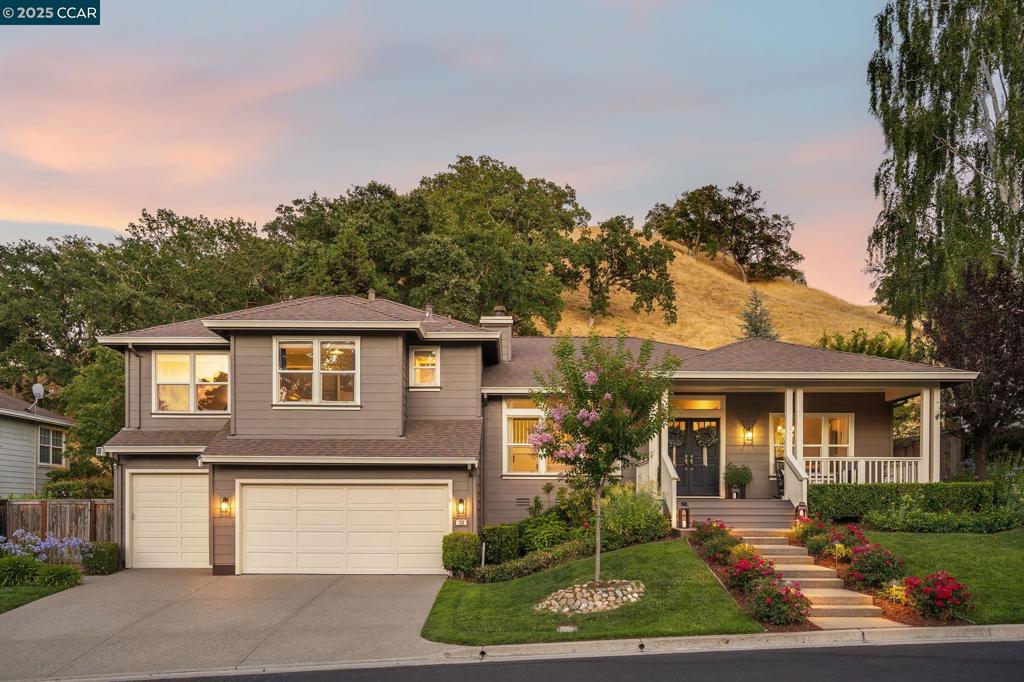 Nestled in coveted Magee Ranch, this beautifully updated 2,939 sq.ft. home features 4 beds and 3.5 baths, offering ample space for relaxation. Enter from the charming porch to soaring ceilings, a modern fireplace, and abundant natural light on rich hardwood floors. The main level's open-concept design includes a spacious living and dining room, plus a kitchen with quartz countertops, stainless appliances, pantry, counter seating and dining area, flowing seamlessly into a family room with custom built-ins and a stone fireplace. A wall of windows provides stunning hillside views. The primary suite upstairs is a retreat with a fireplace, vaulted ceiling, window seat, walk-in closet, and a spa-like bath with dual vanities, heated floors, steam shower, with heated bench seat and soaking tub. Two additional bedrooms, a shared bath and hallway storage complete the upper level. The lower level offers a bedroom/office ensuite bath with a private patio, laundry room, and powder bath. The spacious backyard features multiple entertaining areas, sports court, expansive lawn and hillside views. The 3+ car garage is fully finished with epoxy floor, workbench and an abundance of storage. Located in top-rated SRVUSD, near trails, shopping, dining and offering luxury, tranquility and convenience.