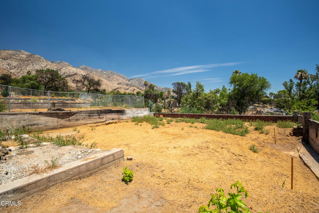 Nestled at the base of Angeles National Forest, this 6,439 sqft lot presents an extraordinary opportunity to design and build your dream home in one of Altadena's most scenic and sought-after locations. Wake each morning to sweeping mountain views from a backyard that abuts county property with green space views. Listen to the sounds of nature and birds, with trailheads just a short stroll away leading to miles of forested beauty.Only minutes from Pasadena's Old Town, offering vibrant dining, shopping, and cultural scene, yet surrounded by the peace and privacy of the foothills. This property truly offers the best of both worlds. Here, you'll find the perfect harmony of nature, community, and possibility.The previous home was lost to the Eaton Fire. The seller can provide architectural plans from the prior residence, which were approved in 2021. According to the Seller, Phase 2 debris removal has been completed. Buyers are strongly encouraged to independently verify future development possibilities and any required remediation with the County of Los Angeles and other appropriate agencies. The property is being sold as-is, with all due diligence the responsibility of the buyer. This is a drive-by only listing. Do not enter or walk on the property for safety reasons.