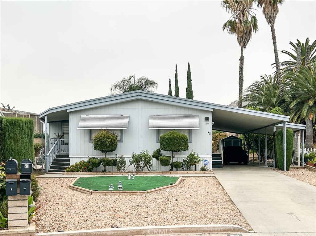 THIS IS A HUGE MOBILE 2 AND 1/2 WIDE IN A QUIET WELL MANAGED PARK FOR FAMILIES. THE LOT IS A LARGE WELL APOINTED PIE SHAPED LOT WITH EXTRA YARD SPACE IN THE BACK AND ON BOTH SIDES. THE CAR PORT IS EXTENDED OUT WITH ROOM FOR PATIO SEATING AND A LONG DRIVEWAY LARGE ENOUGH FOR5 SMALL CARS! THIS HOME HAS BEEN WELL MAINTAINED AND HAS AN AWESOME FLOORPLAN!