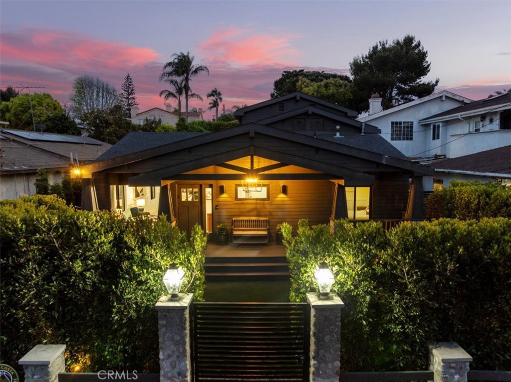 If you are looking for a run of the mill cookie-cutter home in Manhattan Beach, perhaps you should look elsewhere. If on the other hand, you want a home filled with the personality and style that meets your shifting moods, you will love the way this remodeled luxury residence lives. The feeling is inspired from the moment you open the gate and see the trussed beam front porch and private shrouded front yard, reminiscent of classic Pasadena craftsman homes. The first impression at the front door is the great room with island kitchen and black steel doors leading to one of the vignetted exterior yard spaces, seamlessly spreading between the home and the detached two-car garage, which has cleverly been converted into indoor outdoor space, with a glass accordion door that opens 15 feet (and is easily converted back). Lustrous hardwood floors accent the living space. The sparking white cabinets in the chef's kitchen, with its complete array of state of the art appliances, are accented by dark stone counters and pulls. Natural light pours in and drenches the interior with warmth through an array of glass windows and doors. There are three bedrooms on the ground floor with two full baths. Plus a private family room at the back of the home, that is highlighted by a wood burning fireplace, and access to a super cool and very private yard. And there is so much more. Up a flight of stairs on the exterior, is a magical elevated deck AND nestled perfectly at the back of this immense 50 X 150 lot is an amazing elevated pool. As you can imagine, the atmosphere at night is perfectly cerebral; your family and guests alike will discover all of the dreamy spaces on the inside and outside of this home. If it feels as though we are jumping inside, then outside, then back again, this is how the home reveals itself, opening like a flower, to display the wonders within. And the greatest spot of all may be the Primary suite sanctum, perched alone on the second floor, with vaulted wood beam ceilings, and crackling fireplace, two walk in closets, and a luxurious bath with old fashions steeping tub, separate shower, and dual lavs, all lavishly appointed. The best part may be the view from the primary deck across the yard to the pool and pool deck, which are at the same elevation - like the elevated feeling you get throughout this truly unique and glorious home. So convenient to shopping, award winning schools, transportation and of course the most pristine beaches on the planet!