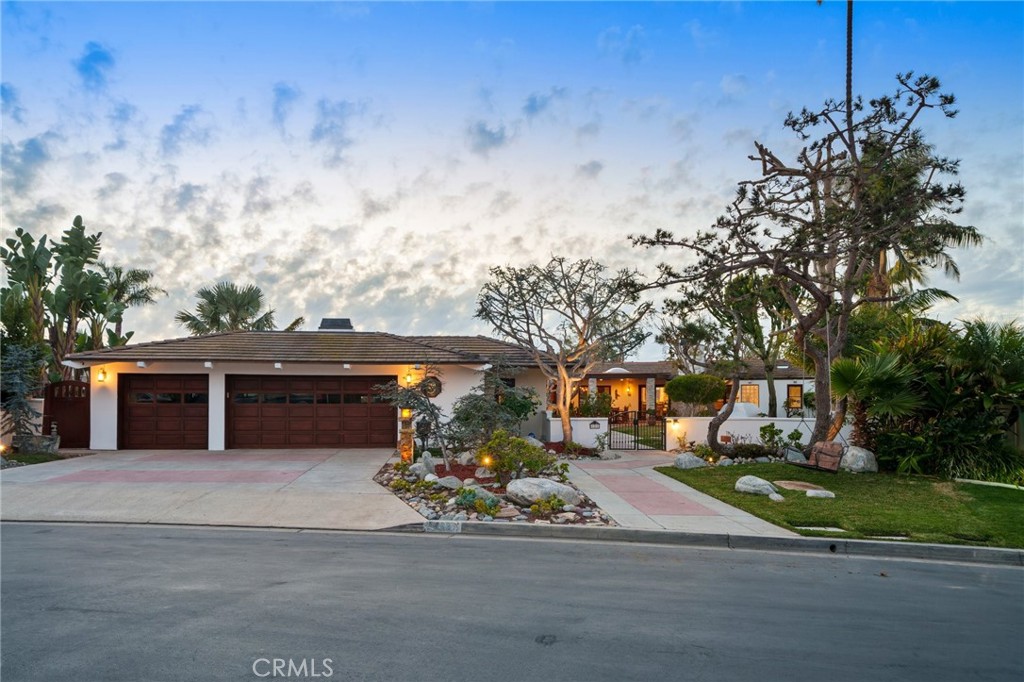 Set within the prestigious, guard-gated enclave of Monarch Bay, this stunning single-level estate offers nearly 5,000 sq. ft. of refined coastal living on one of the community’s largest lots. Located on a tranquil cul-de-sac, the home welcomes you through an expansive gated courtyard into a sprawling retreat designed for both relaxation & entertaining. The lush grounds feature a covered patio w/skylights, an inviting outdoor fireplace & views of Three Arch Bay’s hills & evening lights. Beyond the grand custom entry door, the magnificent great room boasts soaring ceilings, stacked-stone columns, & a floor-to-ceiling marble fireplace, with glimpses of the ocean. The spacious kitchen features stone countertops, an island, stainless steel appliances, an oversized walk-in pantry, & a gracious nook. The expansive primary suite is a private sanctuary, complete with a cozy fireplace, a large walk-in closet, & a French door leading to the serene rear yard. Its luxurious spa-like bath showcases an oversized frameless glass shower, a clawfoot soaking tub & heated towel rack. A secondary primary suite offers elevated ceilings, a walk-in closet, a remodeled marble-accented bath, & a French door opening to the ocean-facing backyard. Designed for versatility, the home also includes two additional bedrooms plus an oversized bonus room featuring an exotic wood ceiling, a stone fireplace, and French doors leading to the courtyard. The rear yard is a peaceful oasis w/mature trees—including Japanese pine, grand magnolia, and oak—complemented by custom stone benches, onyx lighting, a relaxing sauna & views. Additional highlights include exquisite 24” Celini Argento tile, luxuriously remodeled bathrooms, custom lighting, solid wood doors, spacious laundry room with/custom marble pet-washing shower & a massive three-car garage. A separate casita serves as a private office or gym, offering picturesque views of the front grounds & hillside beyond. Residents of Monarch Bay enjoy exclusive access to resort-style amenities including tennis & pickleball courts, a community & dog park, a playground, and the spectacular private beach club—complete with an indoor-outdoor bar, beachfront dining, firepits, & towel, chair, & umbrella service. Ideally located near hiking trails, world-class golf & surfing, & premier coastal resorts like The Ritz-Carlton, Waldorf Astoria & The Montage, this exceptional property is also set to benefit from the exciting Dana Point Harbor revitalization project.