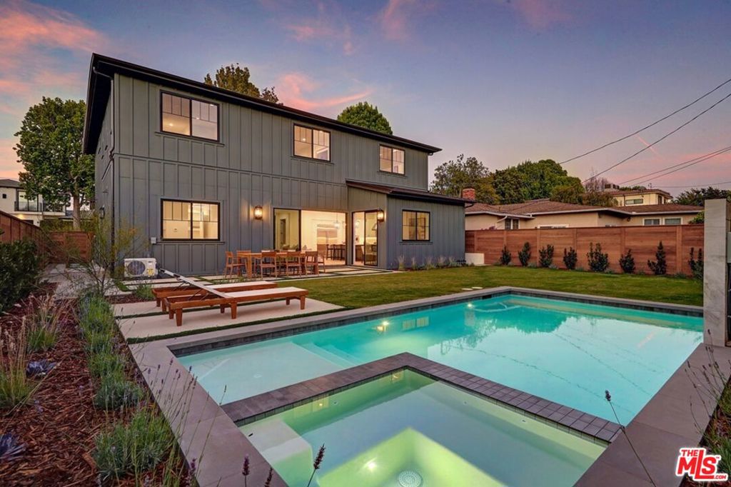 New construction home nestled in a charming enclave of Westchester near top-rated schools, scenic parks, and a beloved neighborhood market. This exquisite modern Farmhouse is a masterclass in design and craftsmanship. Built to perfection by TJH, it showcases the highest quality materials and thoughtful finishes throughout. A gracious entryway leads to formal living and dining rooms anchored by an elegant fireplace. Just beyond the butler's pantry, the chef-inspired kitchen is outfitted with Wolf and Sub-zero appliances, a walk-in pantry, a large center island with bar seating, and a sunlit breakfast nook. The kitchen seamlessly flows into the expansive great room with a striking fireplace and stacking sliding glass doors that open to the backyard oasis, complete with a sparkling pool and spa, ideal for both relaxing and entertaining. The first floor also includes a private ADU with its own exterior and interior entrances and a dedicated kitchenette. Completing the main floor are a full bathroom, a separate powder room, and a mudroom conveniently located off the attached two-car garage. Upstairs features a versatile loft with built-ins, two secondary bedrooms each include ensuite bathrooms and walk-in closets, while the centrally located laundry room adds convenience. The luxurious primary suite is a serene retreat with a spacious walk-in closet and a spa-like bath featuring a dual-sink vanity, freestanding soaking tub, and a walk-in shower.