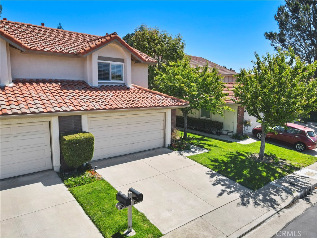 Welcome to this spacious 1,787 sq ft townhome located in the prestigious, guard-gated Porter Ranch Estates community. This home features two large primary bedrooms, each with its own ensuite bathroom and walk-in closet, offering privacy and comfort. A third updated half bath is conveniently located on the main floor. Step into a bright and airy living room with soaring ceilings, hardwood floors, custom drapes, dual-pane windows, and a cozy gas fireplace—perfect for relaxing or entertaining. The kitchen is beautifully appointed with granite countertops, a decorative tile backsplash, including a gas range, built-in microwave, and stainless-steel dishwasher. It opens to a lovely dining area with a custom chandelier, hardwood flooring, and a dual pane sliding door leading to the oasis backyard. Upstairs, both primary suites offer serene retreats. One bathroom features a modern custom shower with built-in shelf, custom seat, and frameless glass. The second includes a tub/shower combo, tile flooring, and a custom mirror. Outside, enjoy a tranquil backyard garden oasis with a lattice-covered patio and built in BBQ, perfect for outdoor dining or relaxing. The two-car garage is fully drywalled for a finished look. HOA amenities include pools/spas, tennis courts, basketball court, playground, BBQ/picnic areas, and 24/7 security with guarded entry. This prime location is just minutes from hiking trails, The Vineyards at Porter Ranch, Whole Foods, coffee shops, restaurants, and convenient freeway access. Don’t miss the opportunity to own in one of Porter Ranch’s most sought-after communities!