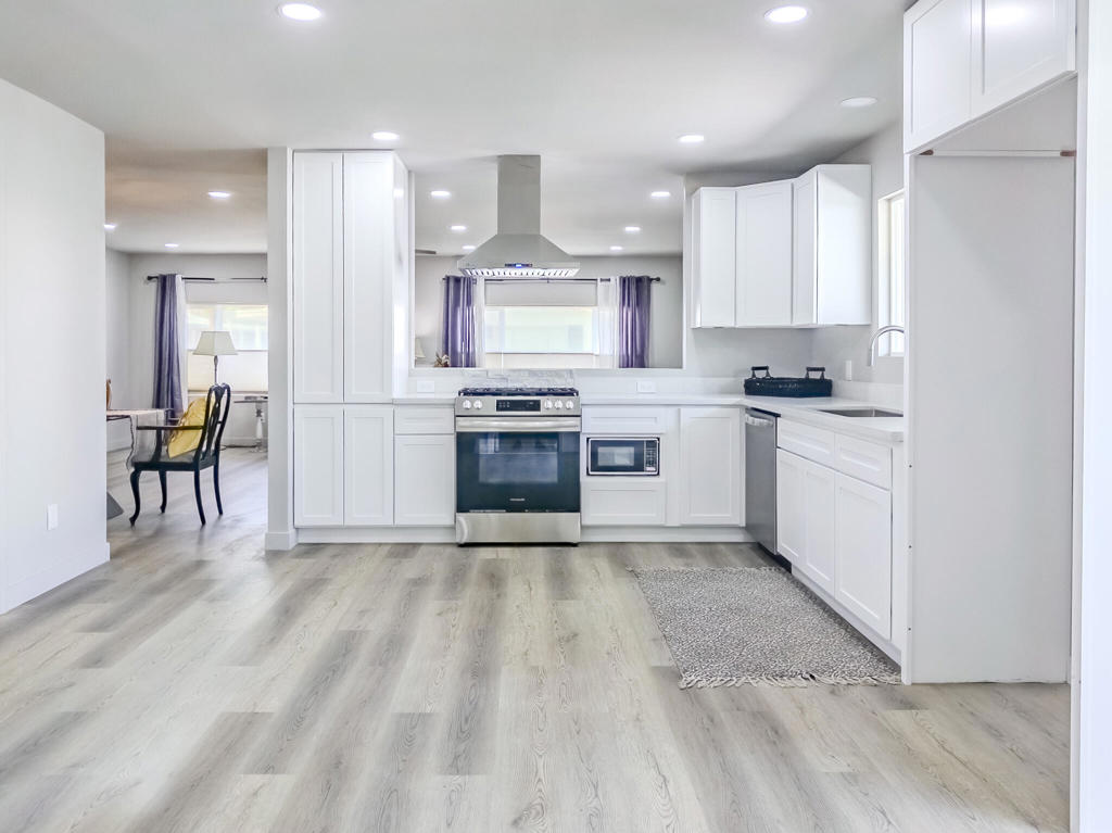 Welcome to this beautifully updated 3-bedroom, 2-bath mobile home offering 1,440 sq. ft. of comfortable living in a prime location close to shops, dining, and amenities. Freshly painted with a charming stucco exterior, the home boasts a bright, open floorplan that seamlessly connects the kitchen and living areas perfect for everyday living and entertaining. The spacious primary suite features an ensuite bathroom, while a second bedroom enjoys direct access to the hall bath, creating a flexible layout. One of the bedrooms is ideal for a home office, adding versatility to the space. The kitchen shines with solid-surface countertops and flows into the living area for a modern, airy feel. Each bedroom and the living room are equipped with efficient mini-split systems for personalized comfort. A brand-new patio welcomes you at the entrance, and the convenience continues with an in-unit washer and dryer. Enjoy your own private driveway with a covered carport, offering ease of parking and additional shade. This move-in ready home blends functionality, comfort, and location into one incredible package.