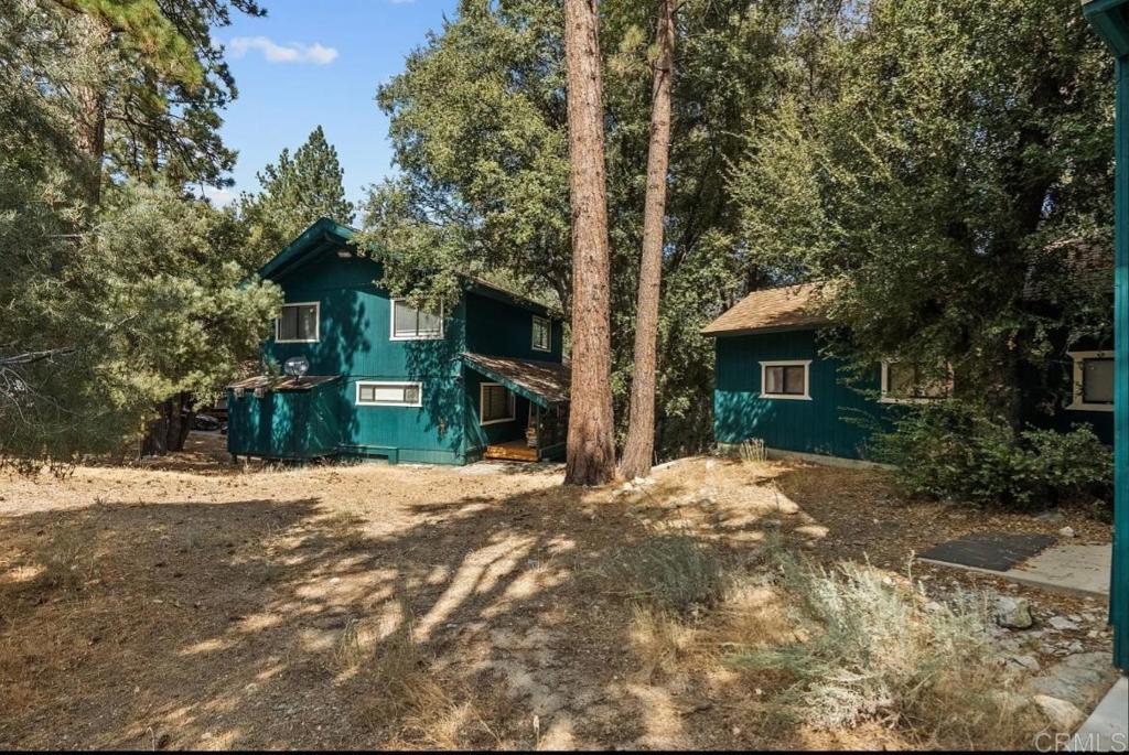 Step into this breathtaking mountain retreat and prepare to be amazed! This majestic 3-story home features not one, but two expansive wraparound decks, perfect for enjoying the lush greenbelt views and two seasonal creeks flowing through the backyard. Inside, you’ll find custom cabinetry, artisan tile work, gleaming hardwood floors, and an open-concept kitchen designed for entertaining. The oversized 15’ x 18’ primary suite offers a luxurious walk-in closet and spa-style bathroom with dual sinks and a massive soaking tub. Upstairs, a spacious loft connects two large bedrooms and a full bath, all overlooking floor-to-ceiling windows that frame the stunning natural scenery. But the real showstopper is the fully finished basement—complete with hardwood floors, cathedral ceilings, a full bar, recessed lighting, and its own private entrance. Cozy up to not one, but two wood-burning stoves, both fully compliant with Kern County standards. And there’s more! The adjoining lot includes a 2,900 sq ft, two-story garage. Upstairs, you’ll find a nearly completed 2-bedroom, 1-bath apartment—perfect for guests, a rental unit, or a workshop. All of this is located just across from the charming Snowflake Trail, a beloved local gem, and within a vibrant community offering amenities like tennis courts, a 9-hole golf course, fishing, a pool, spa, equestrian center, hiking, biking trails, and so much more. This one-of-a-kind property truly has it all—space, charm, and endless potential. Schedule your showing today!