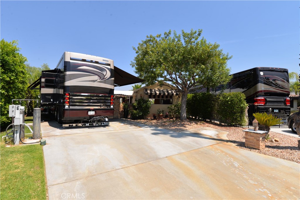 Welcome to THE TOP OF THE WORLD! This cul-de-sac RV lot with custom buildout has sweeping views of mature landscape, golf course, water features and surrounding countryside. Just twenty minutes outside of Temecula, Ca. in the hills of wine country, this sought after property is a must see! With Palm Desert and high end shopping on El Paseo forty five minutes away and the coast just over an hour, this resort RV lot is the ultimate in Southern California living. The lot itself is one of the largest parcels within the resort and provides ample room for your Class A or Super Coach. An established shade tree and mature 12 foot hedge, frames the space and welcomes you into privacy and luxury discerning clients expect. A custom buildout with well appointed fixtures, recessed lighting and design is impressive. Galley style Chefs kitchen with large center island offers custom cabinetry, spice drawers, granite counters and residential grade appliances. Multiple custom electric screens controlled with remotes combined with easy glide sliding screens opens to incredible views, summer time breezes and endless evening stars. Under a pitched 12 foot roof you'll find a laundry area, large dining area with chandelier, open living room for comfortable living, entertaining or just unwind from a day on the golf course. The porcelain tile floor extends beyond the covered living space and onto a panoramic style patio and lawn. The resort boasts a 14 hole executive golf course, 5 pools, spas, tennis courts, pickleball, dog park, general market, restaurant, laundry facilities/showers, fishing lake and variety of resort activities throughout the year. No age restriction.