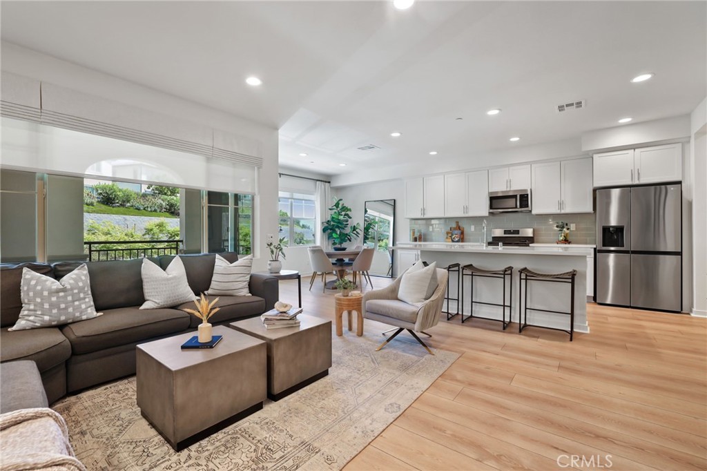 Curated and Designed with a Warm Organic Modern Vibe, this Beautifully Constructed 2022 Residence is the Ultimate At Home Sanctuary. Located in the Gated Resort-Style community of Ironridge this Exquisite Home Has Everything your family has been looking for and more! You are greeted with On Trend Design, Wood Look Luxury Vinyl Flooring that runs throughout the Entire Home and an Illuminating Light & Bright interior providing the Perfect Ambiance for your daily routine. The First Floor Upgraded Office / Multi Use Den with Custom Built Ins and Designer Hardware is an ideal work from home retreat! Upstairs you will find the Heart of the Home with the Gourmet Chefs Kitchen that is bathed in Sunlight & has been upgraded with Modern Technology including Stainless Steel Appliances, Gas Stove, Neutral Quartz Counter Tops, White Drawers & Cabinets, Mosaic Tile Backsplash and the Beautiful Quartz Center Island. Enjoy the comforts of a Spacious Great Room surrounded by windows and natural light complimented by Tranquil Views. Step out onto your sun filled balcony, an outdoor enclave off the great room perfect for that morning cup of coffee and an evening glass of wine. Upstairs you will find 3 Bedrooms and 2 Bathrooms. The Primary Retreat will leave you Well Rested and Calm for a Serene Experience. Ease yourself into a New Wellness Routine in your Spa-like Primary Bathroom, featuring Dual Vanities, Quartz Countertops, Artisanal Tile Flooring, Massive Walk In Closet, and a Walk In Restorative Shower. Additional Upgrades Include a Water Softener, Custom Designer Window Coverings, and a Spacious 2 Car Garage with Epoxy Flooring. The central location of this home enjoys easy walking distance access to Exclusive Resort Style Ironridge amenities including The Clubhouse, Pool & Spa, BBQ’s, Poolside Lounges, Pickleball Courts, Basketball Courts, and Multiple Picnic areas. NO MELLO ROOS! Gorgeous Home!...Come see it quick...Beautiful Home!