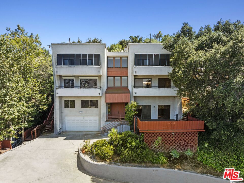 Attention developers, investors and homebuyers! One-of-a-kind opportunity to own and restore this spectacular contemporary tri-level home with stunning city views all around! Featuring 4 beds, 4 baths, ~3481sqft, and ~14,764sqft lot. The house is surrounded by windows and doors to multiple decks to enjoy the views and the indoor/outdoor experience. Upon entering, you are greeted by a beautiful entry way with high ceilings, an impressive staircase and lots of natural light. To your right, you will find a large studio or potentially in-law suite with a full bath, kitchenette, and a large deck with a separate entrance. The living room is spacious and open, with a fireplace, balconies, a wet bar, powder room, and access to the back yard. The kitchen is large and has a lot of storage space, complete with a center island and cooktop. Next to the kitchen, is a breakfast room, dining room, and a laundry room as well. The primary suite includes lots of built in storage, an en-suite bathroom with a bathtub, and a big walk-in closet. Walking to the rare backyard will leave you speechless, surrounded by the lush greenery, mature trees - it is your fully private retreat. A two-car garage and big storage room are included as well. Come see the endless possibilities that 3740 Multiview is offering!