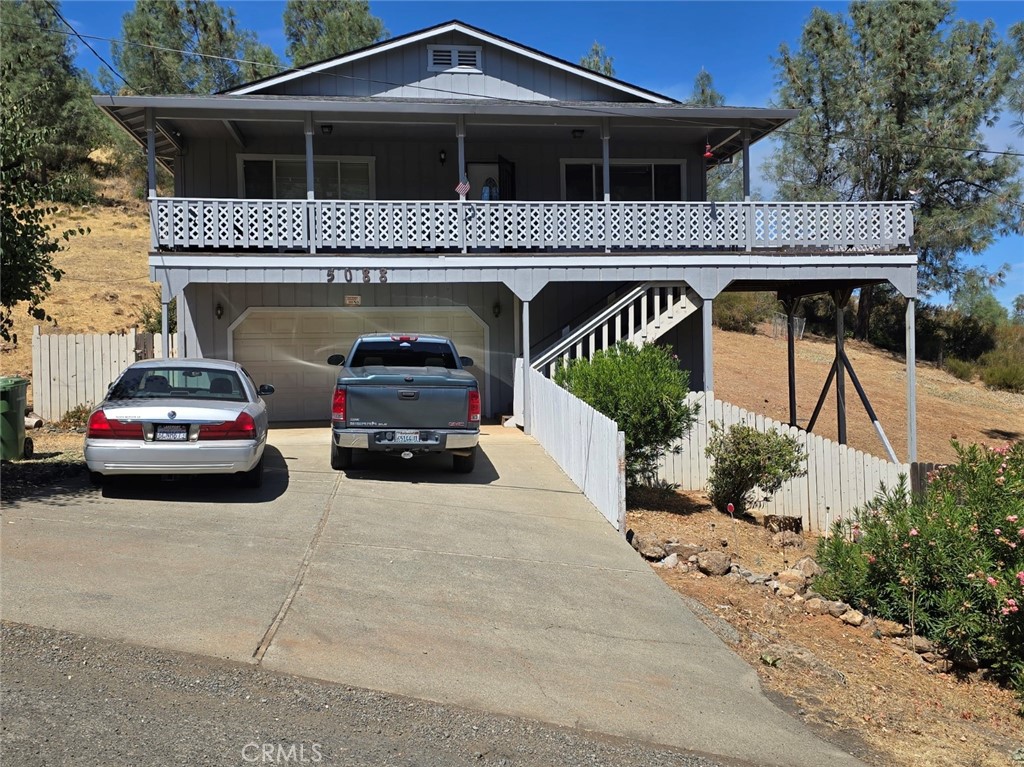 Riviera lake view home, in very good condition, with 3 BD/ 2 BA PLUS a sizable ADDITIONAL ROOM off the 2-car garage, situated on an extra-large lot (nearly 4/10 acre). This home features a huge wrap-around deck with a nice lake view and plenty of room for entertaining and enjoying the great outdoors. All three bedrooms are sizable--no small bedrooms! The roof was replaced, and the exterior was painted, around 4 to 5 years ago. The kitchen appliances, and the washer and dryer, are also 4 to 5 years old. Features also include central heat and air, a wood stove, and a security system. Furniture is included. The propane tank is also included. This home is located in the very popular Kelseyville Riviera area near Konocti Harbor Resort and Spa, four additional restaurants, Riviera Market, several hair salons, Riviera Marina, and more!
