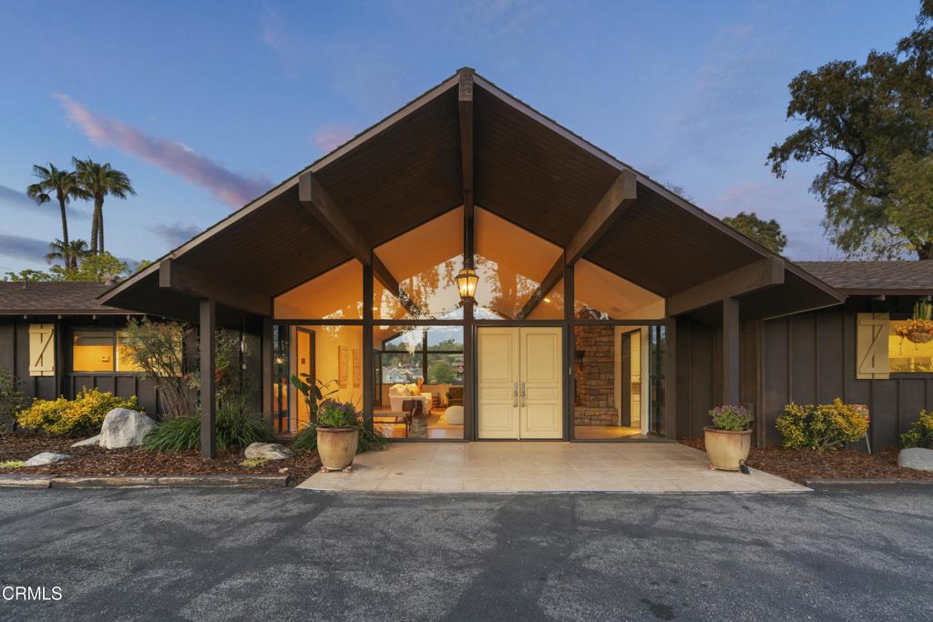 Tucked in the rolling hills just above Camarillo, 230 Avocado Place is a rare mid-century modern retreat located in the coveted Las Posas Estates. Set on 1.83 private, usable acres, this single-story ranch offers timeless architecture, indoor-outdoor flow, and endless potential--all in one of Ventura County's most desirable hillside communities.Built in the 1960s and lovingly preserved, the home offers approx. 2,920 sq ft with 3 spacious bedrooms and 3.5 bathrooms. Vaulted, beamed ceilings and floor-to-ceiling windows flood the living space with natural light and surround you with lush views of mature trees and open sky. The oversized living room, anchored by a dramatic stone fireplace, feels like a treehouse sanctuary. Every room opens to the outdoors creating seamless access to the surrounding grounds.The eclectic design embraces California mid-century style. Warm terra cotta tile in a unique quatrefoil pattern runs through the kitchen and family room. In true retro fashion, the kitchen includes a vintage indoor rotisserie--along with a built-in KitchenAid appliance suite, pull-out shelving, and ample storage. The kitchen flows naturally into the family and dining areas, making it ideal for entertaining. A custom wine room adds a playful and practical touch for wine lovers or those who love to host.The private bedroom wing includes three large bedrooms, each with direct outdoor access. The oversized primary suite includes a private spa nook and ample space to reimagine a true luxury retreat. With 3.5 bathrooms and generous square footage, the floor plan lends itself to both daily comfort and long-term flexibility.Outside, the 1.83-acre lot offers remarkable privacy and room to dream--whether you envision a pool, guest house, studio, garden, or all of the above. With no rear neighbors and direct access to nearby equestrian trails, the property invites peaceful exploration and open-air living. Formerly home to avocado trees and a barn, the land is a rare find in today's market.Las Posas Estates is known for its large lots, scenic roads, and enduring sense of community. Here, homes are often passed down through generations, yet you're only minutes from golf, shopping, dining, freeway access, and top-rated schools.230 Avocado Place is more than a home--it's a one-of-a-kind opportunity to restore, expand, or transform a legacy property into your personal haven.