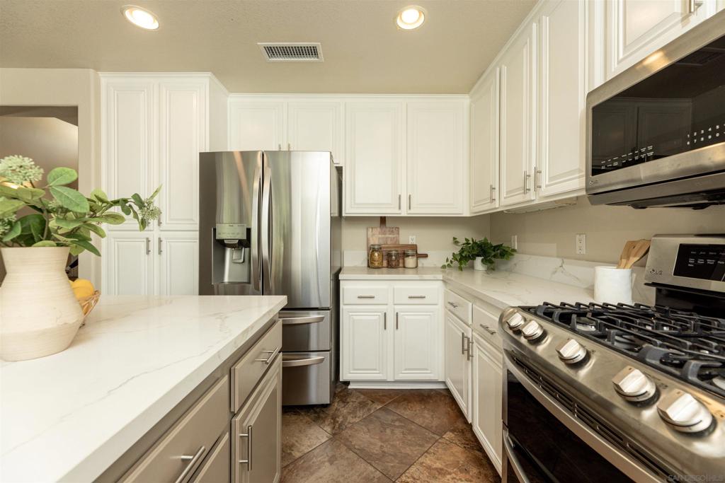 VALUE RANGE $1,234,900-$1,274,900! Welcome home to this 4-bed, 2.5-bath home offering 1,987 sq ft of living space in the highly desirable community of Poway. Situated on a private street shared by only four homes, this property provides rare privacy and exclusivity. Inside, you’ll find a spacious and functional layout with thoughtful upgrades throughout, including tiled flooring downstairs, carpet upstairs, custom shutters, as well as updated kitchen and bathrooms with white cabinetry and quartz countertops. All four bedrooms are conveniently located upstairs, offering a quiet separation from the main living areas and creating the ideal layout. Designed for comfort, the primary suite showcases elegant tilework in the bathroom and large windows that invite in warm natural light. The garage includes built-in storage and an epoxy-coated floor. Step outside to a very private backyard retreat with lush landscaping, fruit trees, a mini garden, and an improved drainage system—perfect for relaxing or entertaining. A redone front patio and side yard enhance curb appeal, and the recently resurfaced private roadway adds lasting value. Major upgrades add peace of mind with owned solar, new HVAC, tankless water heater, and updated fencing. The home is equipped with indoor and outdoor security cameras including a Ring doorbell system for added safety and convenience. Enjoy being just a short stroll away from Old Poway Park, the lively Farmer’s Market, charming shops, and great local dining. Don’t miss this opportunity to own a turn-key home in one of Poway’s most sought-after locations! Broker and Broker Agents do not represent or guarantee accuracy of the square footage, permitted or un-permitted space, bd/ba count, lot size/dimensions, schools, or other information concerning the conditions or features of the property. Buyer is advised to independently verify the accuracy of all information through personal inspection & w/ appropriate professionals to satisfy themselves.