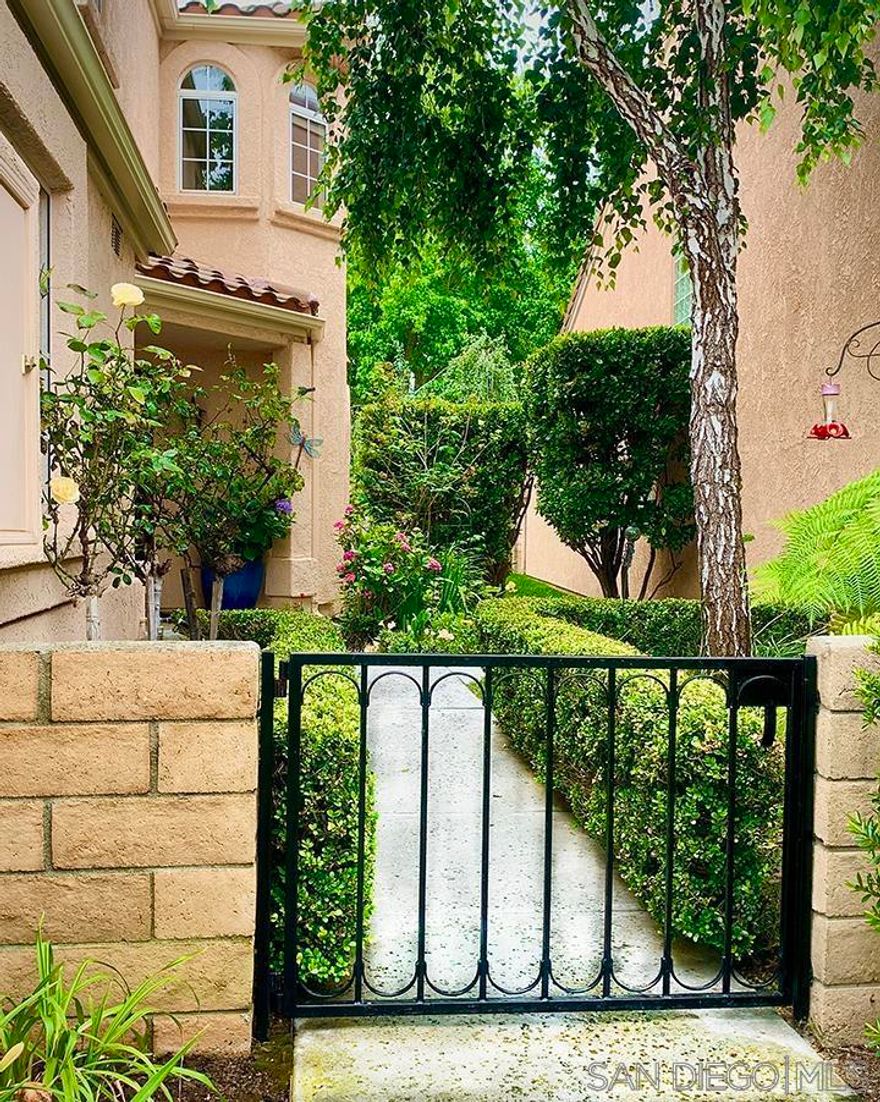 Beautiful!  This move-in ready 4BR/2.5 BTH home in Oxnard's gated Paseo Verde community offers privacy, charm & thoughtful upgrades throughout. Begin at the iron gate that opens to a lush side entry flanked by manicured hedges, colorful mature plants & a graceful birch tree. Inside: formal living & dining rooms, oak stair banister to upstairs pairs w/ oak floor landing. Kitchen features granite countertops, RO water system, stainless steel appliances, newer washer/dryer, and cabinets with pull-out drawers. Cozy family room w/ gas fireplace has a sliding patio door to the rear yard w/ gazebo, matching stone fire ring, bench, and flower beds, grounded on slate, routinely sealed and strategically installed drains and irrigation. A corner waterfall with a variety of colorful plants completes this backyard oasis. Upstairs: Bedrooms, floor to ceiling tile in showers, double sinks. Primary bath has claw foot soaking tub, while the view from the primary bedroom is an amazing green tree-lined view of the park. No need to close a curtain or window that lets the ocean breeze sweep through—only 3.5 miles away (straight line). Water softener and pre-filter included. The house is in immaculate condition. All service and filter maintenance have been performed on schedule according to specifications. Measurements provided by Seller are approximate and not guaranteed.  Seller elected the 4th bedroom upgrade at build out, it appears buildeer did not file with county assesor. This information was provided to Listing Broker by Seller. Listing Broker does not have any other information. Seller to verify all data in this liisting or to check remedies.  Seller installed pre-filter to water softner protecting whole house piping even further. No leaks. House very well cared for. Seller is on a routine termite inspection program.  Seller had a valuation appraisal in Aug 2025, available upon request.