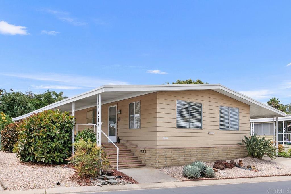 Welcome to El Camino Estates, a gated 55+mobile/manufactured home community in Carlsbad. We are offering this home, one of only 20 in the entire community, for those seeking a quiet tranquil lifestyle, tucked away from the fast pace of everyday living. Well kept, and ready to move in, this 2 bed, 2 bath home is comprised of 1488 square feet of living space. Set across from the clubhouse, and close to guest parking. For storage other than what the home itself provides, there is a stick built shed, with electric outlets and lighting. A small additional shed in the back for gardening tools, all to help maintain the 5,702 square foot yard with its fruit trees, and drought resistant landscape. Maintained to a "T" with records to show.