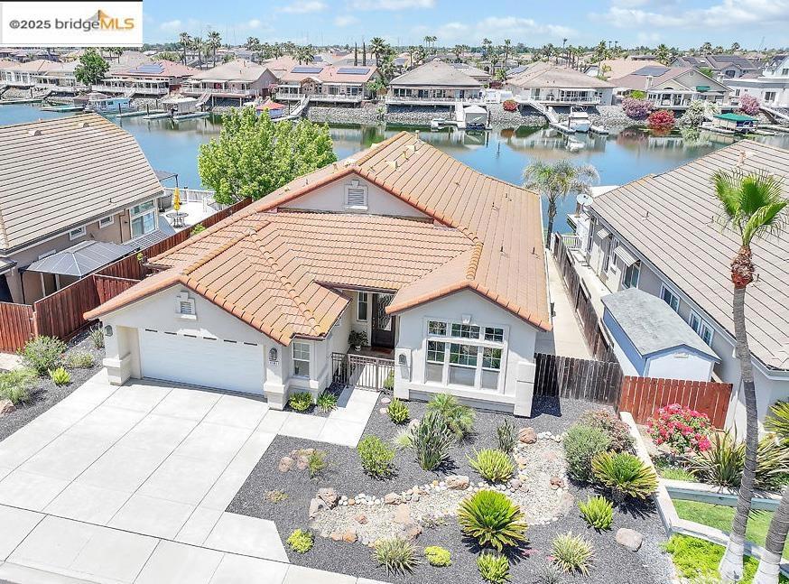 Fabulous waterfront home with private boat dock in Discovery Bay! PERFECT sun exposure, plus covered patio! Welcoming floor plan with the FAVORITE great room/kitchen combo! Wide open and versatile for every decorating idea you can come up with! Incredible breakfast bar and open concept kitchen makes the Chef the life of the party! You can access a thousand mile of Delta Waterways from your own backyard!
