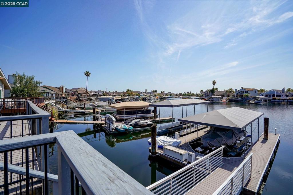 Welcome to waterfront luxury in a prime location at Discovery Bay. Gorgeous single-level, entertainer's delight, WATERFRONT HOME at the end of a quiet cul-de-sac. Prime EASTERN EXPOSURE to the waterfront; offers wonderful morning sun, with comfortable afternoon shade where it matters most. Spacious entertainer’s back deck steps down to the OVERSIZED DOUBLE DOCK with room for 3 boats and includes two hydro hoists with new canopies atop. Upon entering the home, you are greeted by an open great room that seamlessly integrates the dining room and family room with a large chef's kitchen, perfect for both everyday living and entertaining. This spectacular 3-bedroom, 2-bathroom home is perfectly positioned on deep water, and offers 2,229 sq. ft. of refined living space on a wonderful, professionally landscaped, low maintenance lot. Comfort with Central HVAC system plus ceiling fans. Vaulted ceilings, large windows throughout, and two skylight tubes flood the home with natural light. Decorative hardwood flooring at dining, kitchen and family room areas. Gourmet kitchen, designated dining area, and large wet bar at back of family room, all with amazing waterfront views. Home is located close to the marina, yacht club, golf course, shopping center, restaurants, & entertainment.