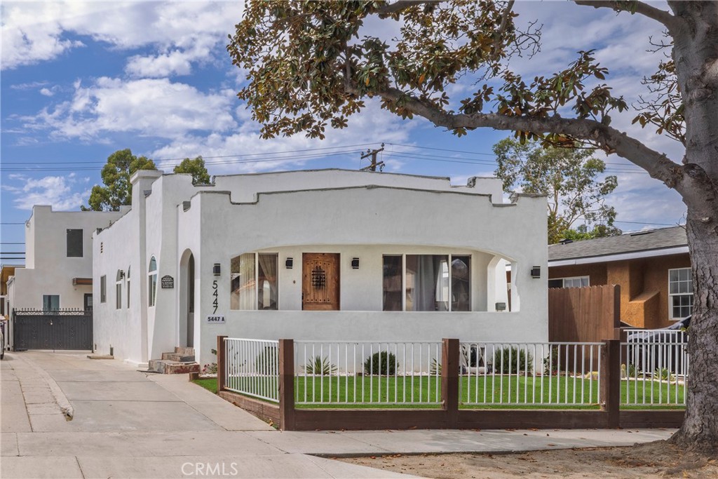 A rare opportunity to own a versatile, multi-unit property featuring three separate residences on one R3-zoned lot—ideal for investors, multi-generational living, or owner-occupiers seeking rental income. Unit 1 – Spanish-Style Front Home (Built in 1927):This charming 2-bedroom, 1-bathroom home showcases classic Spanish architecture with smooth white stucco, a raised front patio, and a turf-covered front yard for low-maintenance curb appeal. Inside, luxury vinyl plank flooring flows through a spacious open floor plan, highlighted by French doors that open onto a large shared yard space—perfect for indoor-outdoor living. Air conditioning, energy-efficient Tesla solar panels, in-unit laundry, brand new electrical, and updated plumbing provide modern convenience while preserving timeless character. Unit 2 – Modern ADU (Built in 2025): Thoughtfully designed for comfort and privacy, this newly constructed ADU includes a bedroom, bathroom with double-headed shower, full kitchen with stove and refrigerator, in-unit laundry, air conditioning and a 144 sq ft loft for added space. The 10-inch thick insulated walls in the living and kitchen areas keep the home cool in the summer and warm in the winter, while the studio-grade insulated bedroom ensures near-silent rest or recording-quality soundproofing for creatives. Unit 3 – Versatile Bonus Unit: Compact and efficient, the third unit includes a full kitchen, bathroom, and a Murphy bed, making it an ideal guest suite, office space, or rental opportunity. The entire property features a fully turfed and paver backyard, providing a clean, green aesthetic and minimal upkeep. With 3-car side parking and prime R3 zoning, the possibilities are endless—live in one unit and rent the others, host extended family, or generate strong income from all three.