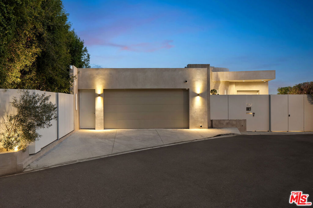 This privately-gated and former celebrity-owned contemporary hideaway sits above it all, with jetliner views stretching from Downtown LA to Century City and out to the ocean. Framed by a dramatic pivot door, the designer-done home opens to soaring ceilings, smooth Venetian plaster, hardwood floors, and sun-drenched interiors that exude a sophisticated and organic feel. The main level showcases a spacious formal living room that flows seamlessly into the dining area and chef's kitchen, designed for both effortless entertaining and everyday living. The relaxing primary suite offers a travertine-cladded spa-like bathroom with walk-in shower and separate soaking tub, a picture window framing endless panoramic vistas, and an oversized walk-in closet. Two additional guest bedrooms are replete with en-suite baths and private balconies, with an additional flexible space that can serve as a screening room, office, or fourth bedroom. Outdoors, this estate takes entertaining to the next level with a newly added outdoor kitchen/BBQ, in-ground spa, sauna, outdoor shower, and dramatic outdoor fireplace with built-in seating providing the perfect stage for al-fresco dining, sunset gatherings, or simply unwinding above the city lights. With a prestigious history, unmatched style, and coveted location just moments from the Sunset Strip and West Hollywood, this residence is truly a private retreat set against one of the most breathtaking backdrops in Los Angeles.