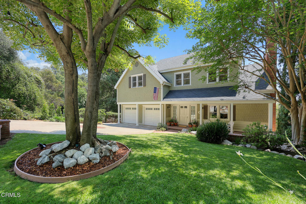 Distinguished and custom-built, this Cape Cod Traditional is located on one of Sierra Madre's most desirable streets offering a sought-after, classic floor plan and handsome architectural details throughout the 3,228 square foot home (measured). Upon entry, the residence reveals a welcoming entryway showcasing beautiful hardwood flooring, wainscoting and crown molding. To the right find an inviting formal living room with marble fireplace and step down to a traditional dining room with convenient connection to the kitchen. Buyers will appreciate the expansive, light-filled kitchen featuring a butcher block island with cooktop, pantry, plenty of cabinets and counter space, room for in-kitchen dining or opt to step out onto the deck to enjoy meals with lovely verdant views. Adjacent to the kitchen you will find a spacious family room with brick fireplace ideal for social gatherings with effortless flow through the French doors to the large deck for added entertainment options. Ascend the central staircase to discover a generously sized primary suite with tree-top views, brick fireplace, walk-in closet and a four-piece ensuite bath. Don't forget to take-in morning sunrises and green foliage from the primary suite balcony. There are three additional, well-sized, bedrooms upstairs for families and guests alike. In addition, you will find two full-sized bathrooms and a laundry room located upstairs. The lovely 8,831 square foot lot reveals a manicured and mature landscape with privacy buyers appreciate. An attached over-sized, double-door garage offers an electric car charger, built-in cabinets and is large enough for exercise or hobbies. Sierra Madre is a treasured community where residents enjoy a small-town feel, popular boutiques, restaurants, hiking, award-winning elementary and middle school, plus a wide variety of year-round community events. Don't miss your opportunity to own this truly distinctive home in an idyllic community.