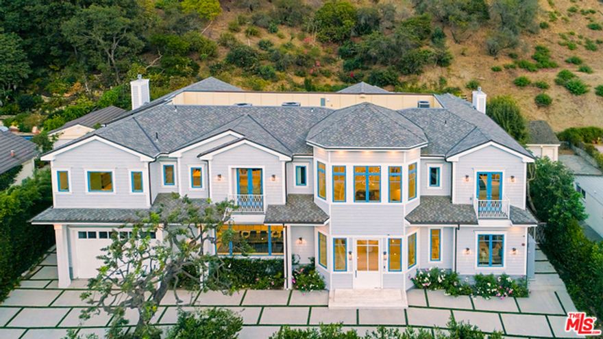 This brand new Cape Cod home is a bold collaboration of a relaxing resort-style backyard alongside a grand detailed-oriented interior located in prestigious lower Bel-Air. The backyard features 20 waterfall features, cascading flowers over the hillside as well as over the falls, multiple bars & seating areas, a fire pit and a large grassy area. The interior features coffered ceilings which lead to two spacious side by side living rooms and an elegant dining room. Designed for entertainment and comfort, the living spaces open up to a chef's kitchen with beautiful marble countertops and backsplash throughout featuring Sub Zero & Wolf appliances. The master bedroom offers his & her showers, a large walk-in closet, and a large balcony. Other amenities in the home include an elevator, wine cellar, 6 total bedrooms, 8-car parking, and a state-of-the-art home automation system.