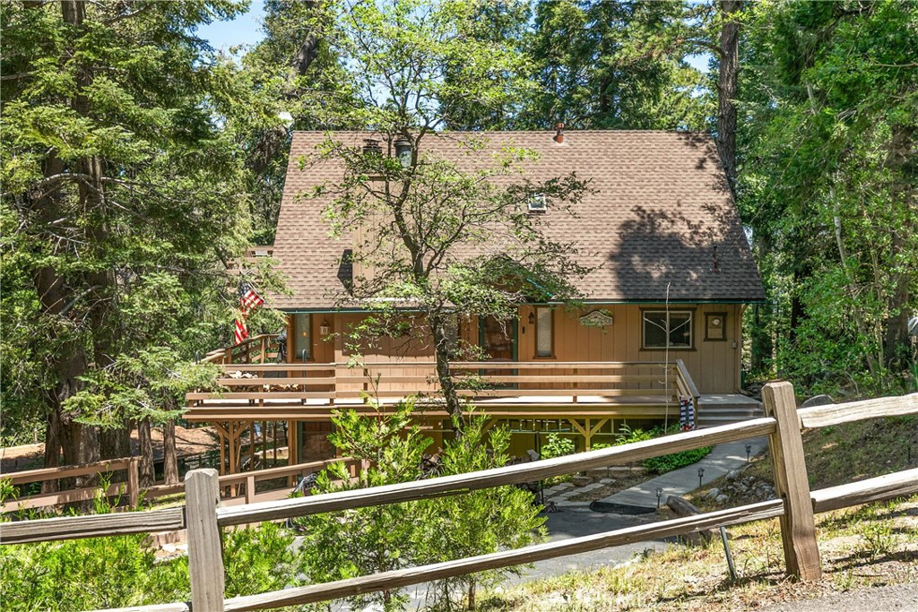 Charming 4-Bedroom Mountain Retreat with Modern Upgrades. Welcome to your perfect mountain getaway! This beautifully updated 4-bedroom, 2.5-bath home seamlessly blends rustic charm with modern sophistication. Thoughtful renovations enhance the warmth of natural wood accents and elegant stone finishes throughout, creating an inviting and harmonious living space. Step inside to an open and welcoming floor plan, perfectly designed for the mountain lifestyle. Expansive windows invite natural light and showcase serene views of towering trees and crisp mountain air, bringing the outdoors in.
The main level features two comfortable bedrooms, while the upper level offers two more—including one with its own private deck, ideal for morning coffee or stargazing. The upstairs bathroom is a spa-like retreat, complete with a luxurious stone walk-in shower and dual vanities. No detail was spared in its design. Downstairs, enjoy a spacious family/game room centered around a cozy brick fireplace—perfect for entertaining or relaxing after a day in nature. Set on a usable and picturesque lot, the property boasts mature trees and ample space to relax, explore, or simply soak in the sights and sounds of the forest. Some of the many upgrades include air conditioning, a tankless water heater, new flooring, smart home features such as keyless entry and a smart thermostat, as well as updated counters, cabinets, fixtures, and lighting. The large driveway provides generous parking—ideal for hosting friends and family who will undoubtedly want to visit your new mountain oasis.