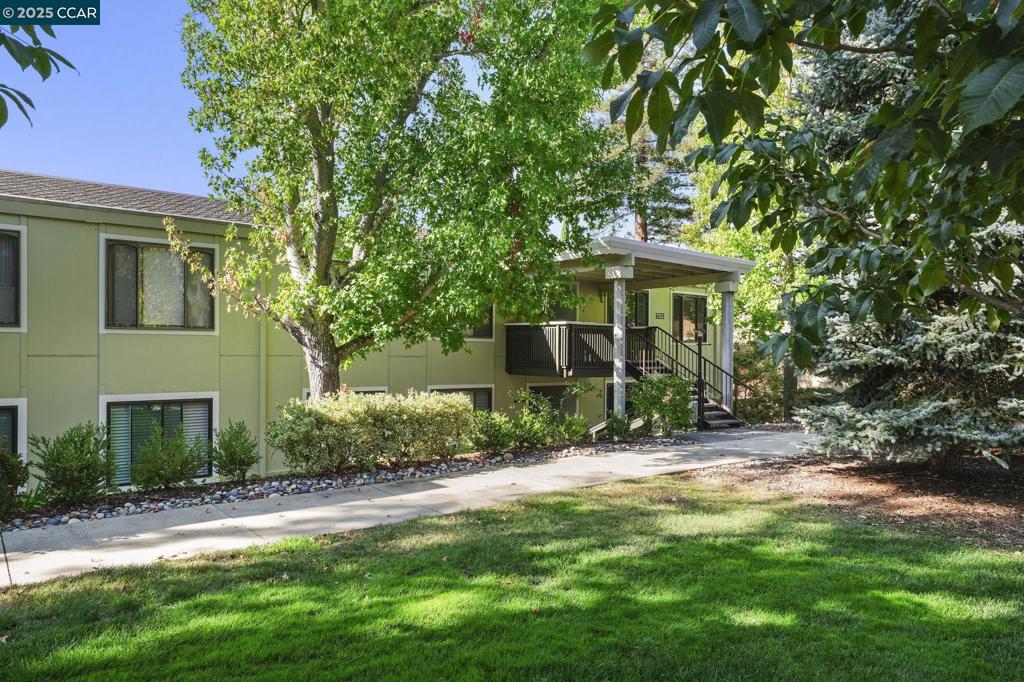 Unique Sonoma wrap model reconstructed to create an extra bedroom, hobby room or office plus a half bath, perfect for guests. The interior has been freshly painted with easy care laminate flooring throughout the kitchen and main traffic areas plus new plush carpeting in the living areas and bedrooms. Spacious kitchen with oak cabinets, Corian counter tops, gas range, dishwasher, refrigerator and a convenient center island. There is a library nook off the dining area and lots of windows, making this home light and bright. The primary bedroom has mirror closet doors and the bathroom features a stall shower, new flooring and convenient stacker laundry. Enjoy the balcony with hillside views or the quiet picnic area near the carport and all the amenities Rossmoor has to offer.