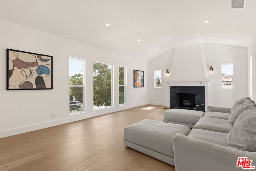 Located on one of Beverly Grove's most desirable and quiet streets, this updated top floor residence of a duplex features 3 bedrooms and 2 bathrooms with a bright, modern layout. The home includes new wide-plank oak flooring, a refreshed kitchen with quartz countertops and stainless steel appliances, and a comfortable living room with arched windows and a decorative fireplace. Both bathrooms have been renovated with modern finishes, and the bedrooms offer great natural light and closet space. Additional highlights include central heating and air, an in-unit washer and dryer, and 1 covered garage spaces. The property is offered fully furnished for a convenient move-in or can be leased unfurnished if preferred. The hedged yard provides privacy and a peaceful setting while being close to Melrose Avenue, The Grove, and West Hollywood. A great opportunity to enjoy an updated home in a prime Beverly Grove location.