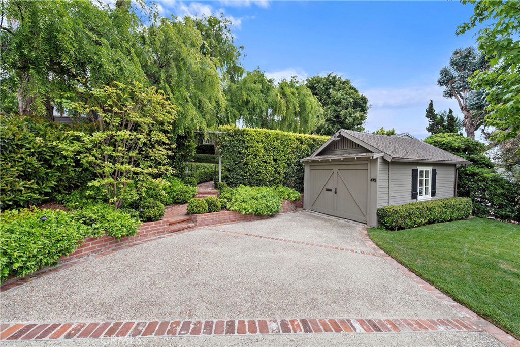 Experience the perfect blend of comfort, style, and luxury in one of the most coveted locations in Laguna Village. This beautifully furnished, single-level home offers the rare charm of 1932 Contemporary Bungalow architecture combined with modern functionality and organic interior design. Set on over 7,000 square feet of prime Laguna Beach property, this private oasis welcomes you through a canopy of mature trees into a serene retreat. Natural light floods the home through wood casement windows, highlighting exposed high-beamed ceilings and warm wood floors that echo the elegance of early Laguna Beach. The sunny retro-style kitchen features custom hardwood cabinetry and offers tranquil treetop views over the canyon, with easy access to a secluded backyard perfect for entertaining. The thoughtfully designed layout includes two spacious bedrooms and two spectacular bathrooms, including a master suite with a walk-in shower and exquisite custom tile work. Designer lighting and fixtures throughout the home add a touch of sophistication, while the detached one-car garage—currently used as a flexible entertainment space or "man cave"—and large driveway provide ample parking. Located on a premier street in Laguna Village, this home offers a perfect 10 for walkability—just moments from world-class dining, boutique shopping, parks, and the iconic beaches of Laguna. Now available for lease, fully and beautifully furnished—don’t miss this rare opportunity to enjoy the Laguna Beach lifestyle in a home with historical charm and modern appeal.