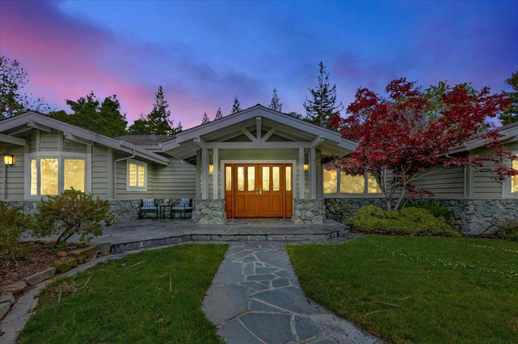 Welcome to 14161 Douglass Lane, this exquisite 1/2 acre estate in Saratoga offers 5 bedrooms & 4.5 baths in a serene & secluded setting. Built in 2006, this home boasts oak hardwood floors with inlay, Andersen windows, vaulted ceilings & skylights: creating a bright & airy atmosphere. The gourmet kitchen features a 6-burner Thermador gas cooktop, 3 warming drawers, dual ovens, & a Bosch dishwasher plus a secondary kitchen ideal for catering or entertaining. Multigenerational living possibilities with a separate lower level that includes two spacious bedrooms, full kitchen and family room/library with built-in bookshelves plus a sweeping staircase leading to the backyard. The backyard is a paradise with mature redwood trees, pool built in 2019, outdoor shower, custom gazebo freshly painted, and a Viking BBQ grill. Equipped with a Generac backup generator & room for boat/RV parking. Enjoy award winning Saratoga High School, proximity to downtown Saratoga & major Silicon Valley companies.