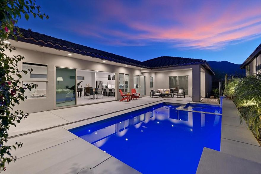 Gorgeous Woodbridge Pacific home on a unique lot in Signature at PGA West with no homes immediately behind providing south mountain views from the new Teserra-designed pool, spa and patio.  Built in 2021, this 3-bedroom, 2-bath, 2131 square foot contemporary home is one of the larger single-level floor plans in the community.  The great room floor plan features a floor-to-ceiling fireplace surround topped by a flat-screen TV on a unique motorized bracket system. These original owners are full-time desert residents, and they have added over $200,000 in upgrades to make this home uniquely theirs.  Things like the 15-foot disappearing wall of glass between the great room and the pool/patio providing a spectacular indoor-outdoor living and entertaining experience; motorized Hunter-Douglas window coverings throughout the home; Solid wood doors; upgraded kitchen cabinetry and appliances; and much more. A full list is available upon request.  The 16-panel owned solar system assures easily manageable energy bills in any season.   Examples of monthly utility charges are also available on request.  The Signature community is one of only three in all of La Quinta that allows short term rentals (STVR) making this an ideal property for investors as well as full or part time occupancy.