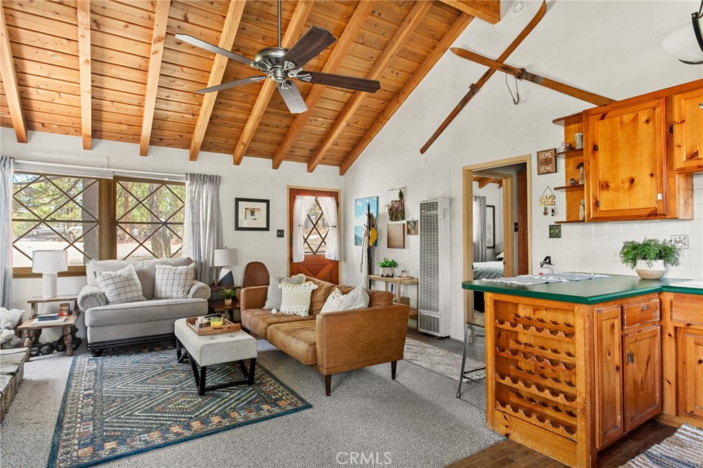 Welcome to your dreamy mountain escape on Dream Street! This charming, single-level cabin is one of the coziest finds in Big Bear Lake. Tucked beneath a stunning, vaulted T&G wood beamed, A-frame ceiling, the open-concept layout is flooded with natural light, creating a warm and inviting atmosphere from the moment you step inside. The thoughtfully designed kitchen, breakfast bar and dining area are perfect for entertaining or enjoying a quiet weekend in. Cozy up to the stone fireplace inside or step outside to expansive front and back porches—ideal spots for sipping your morning coffee or winding down with a glass of wine under the stars. With two comfortable bedrooms, a full-size bathroom, a laundry and storage room downstairs, and a level, two-car driveway for easy year-round access, this cabin has everything you need. Located just minutes from Big Bear’s best—skiing, hiking, shopping, dining, and the lake—this gem is perfect as a full-time residence, weekend retreat, or a fantastic investment property (formerly featured on Airbnb Plus' exclusive platform). Don't let this perfect cabin pass you by!