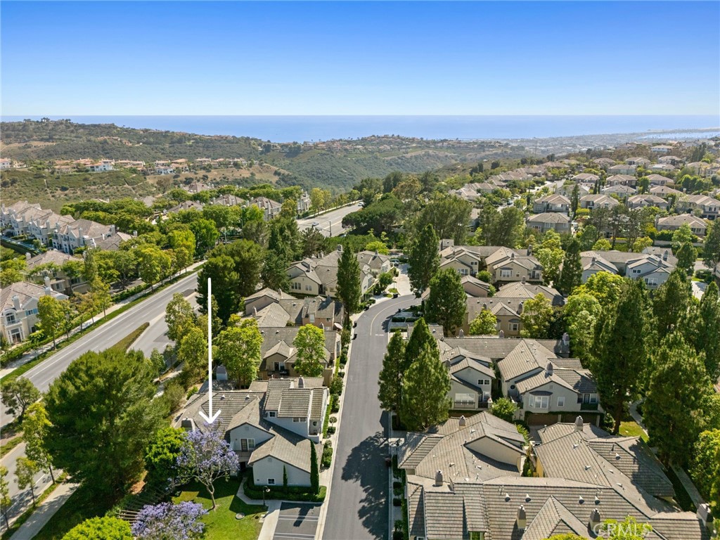 Nestled within the prestigious gated community of The Summit, this beautifully maintained home offers the largest floor plan in the neighborhood with 3 bedrooms, 3 bathrooms, and 1,720 square feet of thoughtfully designed living space. A rare main-level bedroom and full bath add flexibility and convenience, while the bright, open-concept kitchen features white cabinetry, granite countertops, stainless steel appliances, and seamlessly flows into the spacious living and dining areas. Upstairs, both bedrooms include en-suite bathrooms, walk-in closets, and private balconies—creating personal retreats filled with natural light. The private patio is perfect for outdoor dining and entertaining, surrounded by lush landscaping. Additional highlights include central air conditioning, plantation shutters, and a direct-access two-car garage with ample built-in storage and a 240V outlet for EV charging. Residents of The Summit enjoy access to resort-style amenities including a pool and spa and a nearby park with a playground and tennis courts. Ideally located close to upscale shopping, fine dining, scenic hiking trails, and world-class beaches, this home captures the best of coastal living.