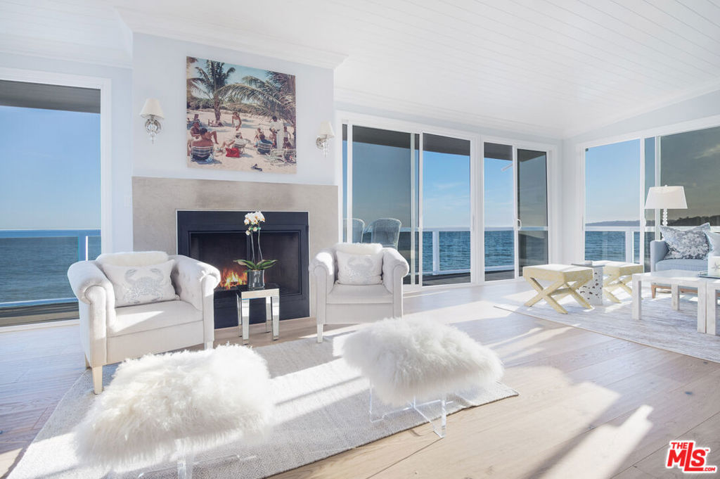 This meticulously remodeled triplex is set on one of the most pristine stretches of Malibu Road, boasting over 50 feet of beach frontage. The top floor is a stunning penthouse spanning approximately 3,000 square feet, featuring 3 spacious bedrooms including the primary suite with an entire room dedicated to the closet, an office, and 4 luxurious bathrooms. The expansive great room, which stretches across the entire front of the home, opens seamlessly to a private oceanfront deck, offering breathtaking views. Below, two additional units mirror each other in design, each offering 2 bedrooms, 2 bathrooms, and a dramatic double-height oceanfront great room that leads to a private patio with direct access to the beach.The property also includes a 4-car garage, plus an additional enclosed space ideal for a golf cart or smaller vehicles. Situated on one of Malibu's most coveted beaches, this home enjoys direct access to miles of sandy coastline, while being centrally located near six shopping centers, offering a variety of restaurants, markets, and retail shops.