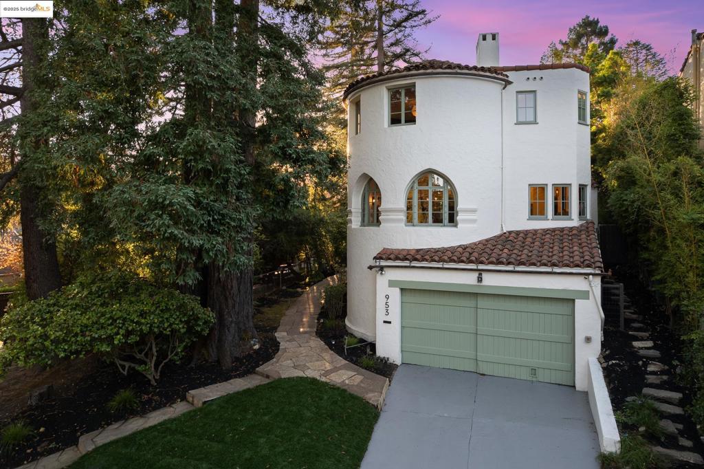 Exceptional Spanish Revival designed by Lionel Henry Pries, blending timeless architecture with modern comfort in coveted Crocker Highlands. Nestled among tall evergreens, this light-filled home features white stucco walls, a red clay tile roof, arched divided-light windows and a charming arched entry framed by wrought-iron accents. In the luminous grand living room an artisan-forged centerpiece chandelier evokes old-world romance and Moorish elegance beneath vaulted ceilings and exposed beams, complete with fireplace. The formal dining room sits in a dramatic octagonal turret, while the chef’s kitchen offers quartz countertops, custom cabinetry, a pro-grade Bertazzoni range and breakfast bar. A main-level ensuite bedroom featuring a wood burning fireplace doubles as guest suite, au pair space, or den, opening to a private patio with brick fireplace. Upstairs lives a serene primary suite plus additional ensuite bedroom with lounge nook. The bathrooms feature a mix of marble, hexagon tile, Venetian plaster and modern fixtures. The lower level includes a spacious garage ideal as gym/flex space, a separate laundry room and additional storage.  Near Crocker Highlands Elementary, Lake Merritt, shops & SF access.
