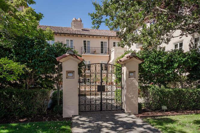 Welcome to this extraordinary 2 bedroom, 2 bathroom condominium located in an elegant Spanish revival style building with a large courtyard and welcoming fountain. Spanning approximately 1,600sf, this unit located on the first floor, offers a blend of comfort and modern amenities. The formal entry with 2 closets leads to the grand living room boasting a striking fireplace and a delightful dining room adjacent to the recently updated kitchen equipped with newer appliances, including a dishwasher, microwave, electric oven range, refrigerator, and a wine refrigerator. The home features high ceilings and beautiful hardwood flooring throughout, adding elegance and warmth to the living spaces. The 2 spacious bedroom suites have ample closet space and one of the bedrooms has a tiled alcove that can be used as an office or workout area. Enjoy cozy evenings by the fireplace, and appreciate the convenience of central air conditioning and heating for year-round comfort. A washer and dryer are included tucked away in the hall bathroom. With one garage space and a separate storage space in the basement, this home offers both practicality and style in a sought-after location in the Baywood neighborhood close to downtown San Mateo.