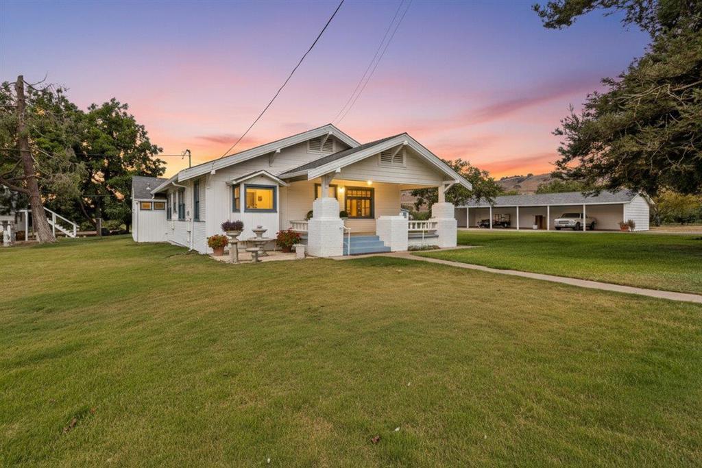 Discover this exceptional 20-acre ranch featuring a producing apple orchard with approximately 5,000 mature trees, offering outstanding agricultural and income opportunities. The centerpiece is a beautifully updated 1920s 3-bedroom, 2-bath farmhouse with fresh paint, new flooring, spacious living and family rooms, and a fantastic kitchen designed for entertaining. Additional residences include a separate 1,100sf 2-bedroom, 2-bath manufactured home in excellent condition currently rented month-to-month for immediate income plus two cabins, each with kitchens and bathrooms, providing even more flexibility for guests, extended family, or rentals. The property also boasts a huge detached shop, a 6-car carport, and the convenience of both a residential well and a separate agricultural well. With multiple legal lots, this rare offering combines country charm with modern updates, abundant resources, and endless income potential.