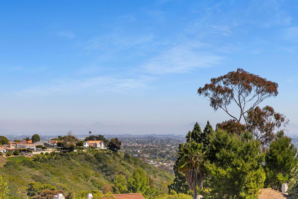 Looking for a deal? A home you can lock and leave and turnkey? Stop scrolling, you found it!! New wide plank french oak style wood floors, new tile in baths and new baseboards and carpet! The last model match sold for $1,595,000!! AMAZING VIEWS in this beautifully updated two bedroom, two-and-a-half-bathroom home at the end of a cul-de-sac in the 24-hour guard gated Windmere community. Open beam cathedral ceilings greet you in the entry with brand new hardwood flooring and breathtaking sit-down views of the La Jolla hillside from the living room, dining area and kitchen. The kitchen, living and dining areas are upstairs to take in the views and all rooms have newly installed hardwood floors. Downstairs are two generously sized bedrooms, both en-suite with brand new tile in both baths. The primary bedroom has a spacious walk-in closet. There's also plenty of storage in the garage as well! It's a short two minute walk down to the clubhouse from your home to relax at one of the pools, play tennis, pickleball, racquetball, basketball or relax at your private park with a lake. Windemere offers unparalleled amenities you won't find anywhere else along the San Diego Coastline - there's even RV parking! This is a true "lock and leave" home. An absolutely perfect second home or use it as your primary. The lowest priced home currently available in Windemere by $475,000!! Hurry before it's gone!