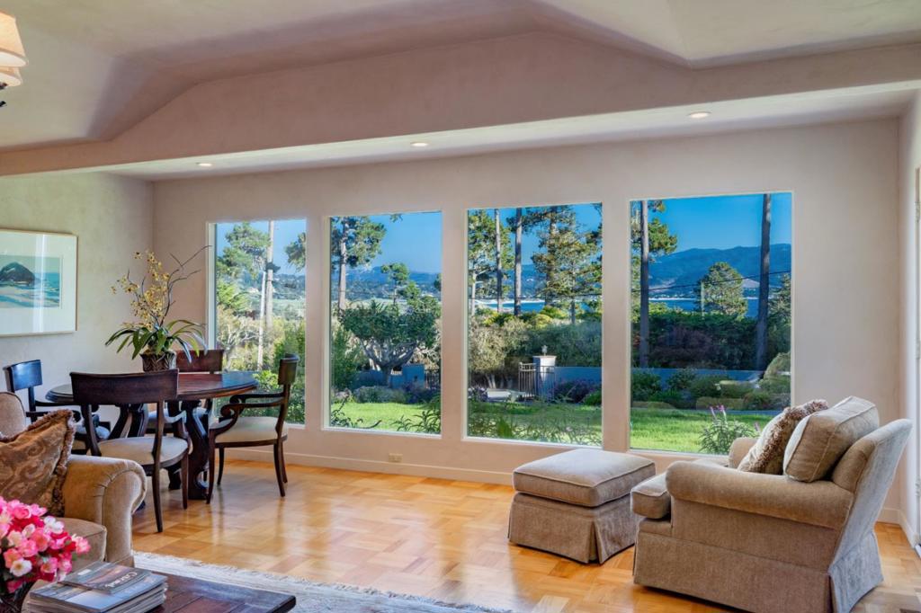 On over an acre, this gracious, gated, single-level Pebble Beach Estate enjoys a rare location in short proximity to The Pebble Beach Lodge, the Pebble Beach Golf Academy, the Hay Golf Course Hay's Place restaurant, and the Pebble Beach Market. Walls of picture windows offer panoramic views of the Pebble Beach Golf Links, Carmel Beach, Pacific Ocean, and sunlit views over the Santa Lucia Mountains. Light and bright spaces with skylights throughout, this home is perfect for entertaining in an open floor plan with an updated kitchen, large living room and dining area. An expansive backyard, private patio, beautiful gardens, and paved walkways complete the indoor/outdoor living spaces. The spacious primary suite features two full bathrooms and abundant wardrobe space. Three additional guest rooms plus an attached studio guest house with full bathroom and kitchen add to this inspired offering. The generous 3-car garage offers plenty of guest parking and abundant storage inside and out.