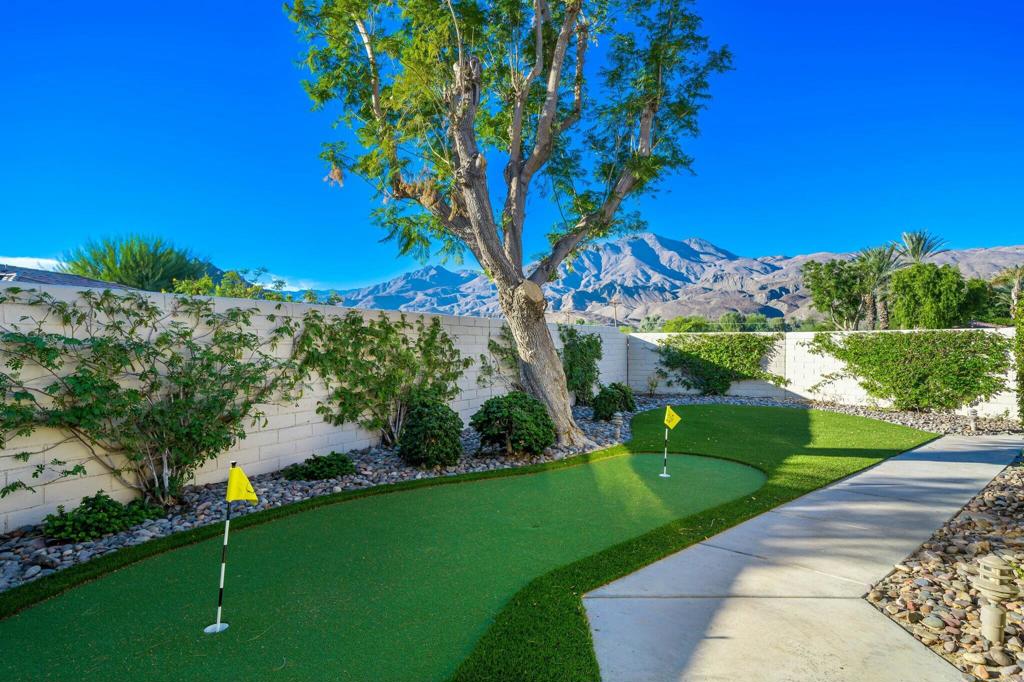 Welcome to 57916 Interlachen in the heart of PGA West! This 3-bedroom, 2-bath home is perched on an elevated lot, giving you incredible lake, mountain, and double fairway views along the 14th hole of the Jack Nicklaus Private Course. The back patio, right off the great room, is the perfect spot to entertain guests or relax as you take in stunning sunrises and sunsets. Outside, the courtyard is a showpiece, complete with a private putting green and breathtaking views of Coral Mountain that set the perfect desert vibe. Step inside, and you'll love the open Trophy 3 floor plan that's made for both everyday living and hosting friends. The remodeled kitchen is modern and stylish, while the formal dining area is ready for memorable dinners and celebrations. The primary suite is a peaceful escape, featuring a spa-like bathroom, a large walk-in closet, and its own private patio where you can enjoy your morning coffee. Located in the sought-after PGA West community, you'll be close to great shopping, dining, and all the excitement of the annual American Express tournament. With a community pool nearby and a golf cart included, this home makes it easy to dive right into the desert lifestyle. Here's the best part: it's being sold fully furnished, so you can move right in and start enjoying. Don't miss out schedule your private showing today!