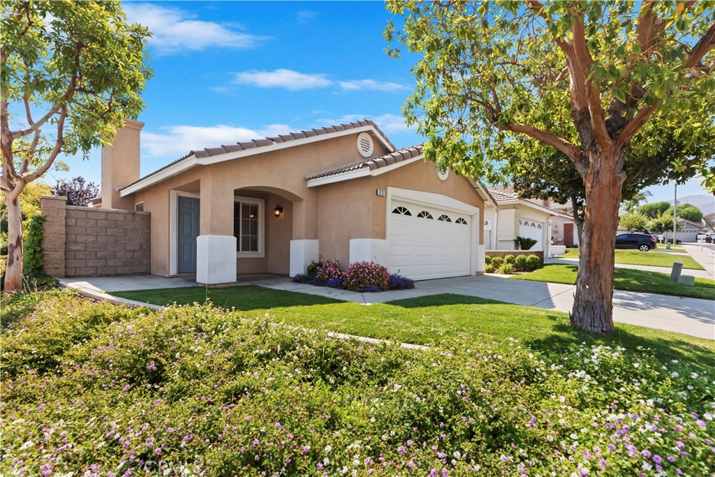 Welcome home! 3125 Andaluz is dialed in, turn-key, and ready for you to move in. Nestled in the green foothills of the Cleveland National Forest in South Corona, this single-story corner lot boasts 3 bedrooms, 2 bathrooms, and over 1,200 square feet of living space. Just a few years ago, the home underwent an extensive remodel that included new durable tile flooring, baseboards, fresh paint, recessed lighting, blinds, updated electrical outlets and switches, modern light fixtures, and even new toilets. Upon entry, you'll notice the vaulted ceiling in the living room and thoughtful modern touches like a built-in space for a media center. The kitchen was completely remodeled with white shaker cabinets, granite countertops, a large ceramic sink, and stainless steel appliances. The primary bedroom features views into the backyard, two closets, and an attached bathroom that includes a newer vanity and an ADA-friendly walk-in shower—fully tiled with a bench and a detachable showerhead. The two additional bedrooms and second bathroom have also been tastefully remodeled. Outside, you’ll find a concrete patio covered by a long-lasting Alumawood pergola—ideal for outdoor dining and relaxation. The home is surrounded by a handsome slumpstone wall and beautifully landscaped with mature trees, shrubs, and flowers. Additional features include a new Lennox HVAC system valued at $17,000, a new water heater, a refreshed and rewired garage with an adjusted and repaired door, and included appliances such as a refrigerator, washer, dryer, and a Nest thermostat system. Low. HOA provides landscaping and a community park and picnic area. Located within walking distance to top-rated schools, scenic parks, and hiking trails—and just a short drive into Orange County—this gem of a home is not to be missed. Schedule your viewing today!