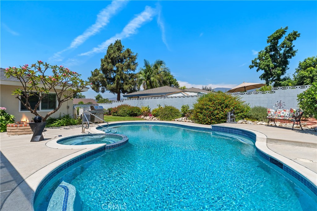 GORGEOUS SINGLE-LEVEL POOL HOME JUST LISTED IN CLAREMONT! This 1,874 sqft 3 bed, 2 bath home sits on a a quiet cul-de-sac street and has been lovingly maintained by the long-term owner. Features include dual-pane windows & sliders throughout with custom vinyl shutters, stone tile & plush carpet flooring, crown molding, oversized living room with cozy gas fireplace & decorative glass media, and a long galley kitchen with granite countertops & backsplash, convenient breakfast nook, recessed lighting, updated cabinetry with pull-out shelving, double oven, and separate pantry. Also includes oversized living room, separate dining area, and relaxing family room with built-in cabinets & shelving. The inside laundry is located just off the kitchen and can be closed off with pocket doors to keep the living areas quiet. Facing the front of the home is the big master bedroom with mirrored wardrobe doors and an en-suite bath featuring updated granite countertop vanity with modern hardware, and a step-in shower wrapped in Travertine stone tile and finished with a heavy-hinged frameless glass door. The home also includes two additional bedrooms facing the back of the home and a full guest bath with oversized soaking tub, Travertine stone tile, and updated vanity with granite countertop. The house stays cool with central AC, as well as several cooling fans throughout and a fantastic whole-house fan to clear the hot air in minutes. Out back is a big yard with full-length covered patio area, gas fire pit and a sparkling pool & spa to beat the summer heat! The 10,105 sqft yard also features a big grassy area for pets or play on one side of the home, and a paved area on the other side to store maintenance equipment & trash cans - all surrounded by sturdy block wall fencing and secured by locking wrought iron gates. Other features include a covered double door front entry, corner-lot location, and 2-car garage with epoxy flooring, work bench & added storage. No HOA to keep your monthly costs low and located close to schools, shopping, park & recreation areas, and the Foothill Fwy!