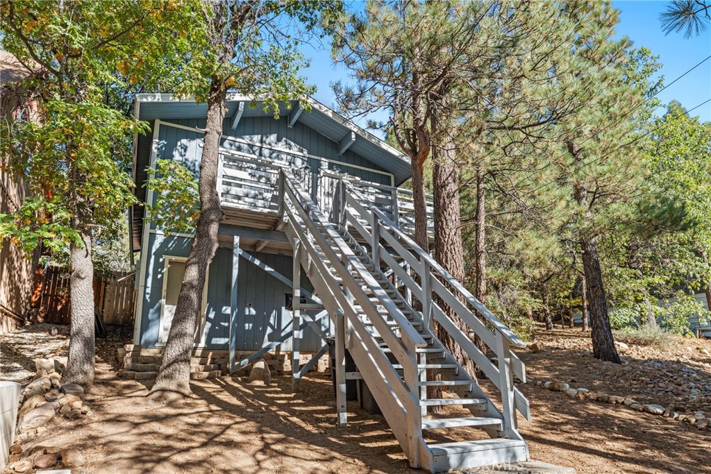 WELCOME to this charming cabin nestled in the serene Sugar loaf neighborhood. Perfectly situated just minutes from the Lakeside ski slopes and a network of hiking and biking trails this cabin is an outdoors enthusiast dream. Inside you’ll find modern updates including scratch resistant flooring sleek quartz counter tops and fit fresh paint throughout step outside into a tranquil private backyard thoughtfully designed for relaxation the elevated entrance and balcony offer the ideal spot for morning coffee with stunning views of the surrounding scenery additional features including spacious storage area under the house perfect for storing away all your seasonal gear and convenient laundry hook ups to newly created parking spots directly in front of the property at the ease of living in this mountain retreat it is a must see! Sold As Is.
