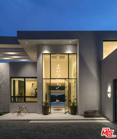 On one of the most coveted streets in Bel-Air sits this brand new modern masterpiece. Nestled behind a private gate is the jewel of Cain Interiors most recent achievement. This fully modern home boasts stunning panoramic canyon, city, and ocean views that are all accentuated by the collapsible walls of glass that enable the owner an indoor-outdoor living space that is second to none. The exquisite interiors include a staggering living room with an expansive outdoor entertaining area complete with an infinity edge pool hot tub. The outdoor entertaining area also includes a full bar and barbeque as well as the attached two bed two bath guest living wing. The expansive nine bedroom, and fourteen bath residence takes its cues from ultra-luxurious resort living. This includes the hotel-style lobby, elevator, penthouse style master bedroom with its own private pool. This estate is the apex of Bel-Air luxury living.