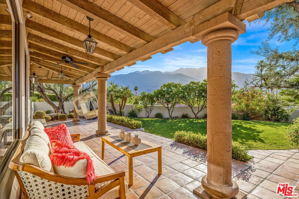 Nestled in a private enclave of exclusive homes in Arby Estates, this stunning Spanish Estate exudes old-world charm blended seamlessly with modern luxury. Perched to capture sweeping canyon views, this rare Palm Springs gem offers the ultimate in resort-style living. Step inside to soaring high wood-beamed ceilings, rich Spanish tile floors, and an open-concept layout ideal for entertaining. The chef's kitchen is a culinary dream, featuring custom cabinetry, stone countertops, and high-end appliances. The spacious family room flows effortlessly to the outdoor living space, where a Pebble Tec pool and spa await, set in a serene, beautifully landscaped yard that offers both privacy and tranquility. The expansive master suite is a peaceful retreat with a spa-like en-suite bath, complete with double vanities, a soaking tub, and a walk-in shower. Additional highlights include a two-car garage, a state-of-the-art solar system with Tesla batteries, and thoughtful touches throughout that showcase craftsmanship and care. Whether you're lounging poolside, hosting gatherings, or soaking in the scenic canyon vistas, this estate is a rare find offering the best of Palm Springs living.